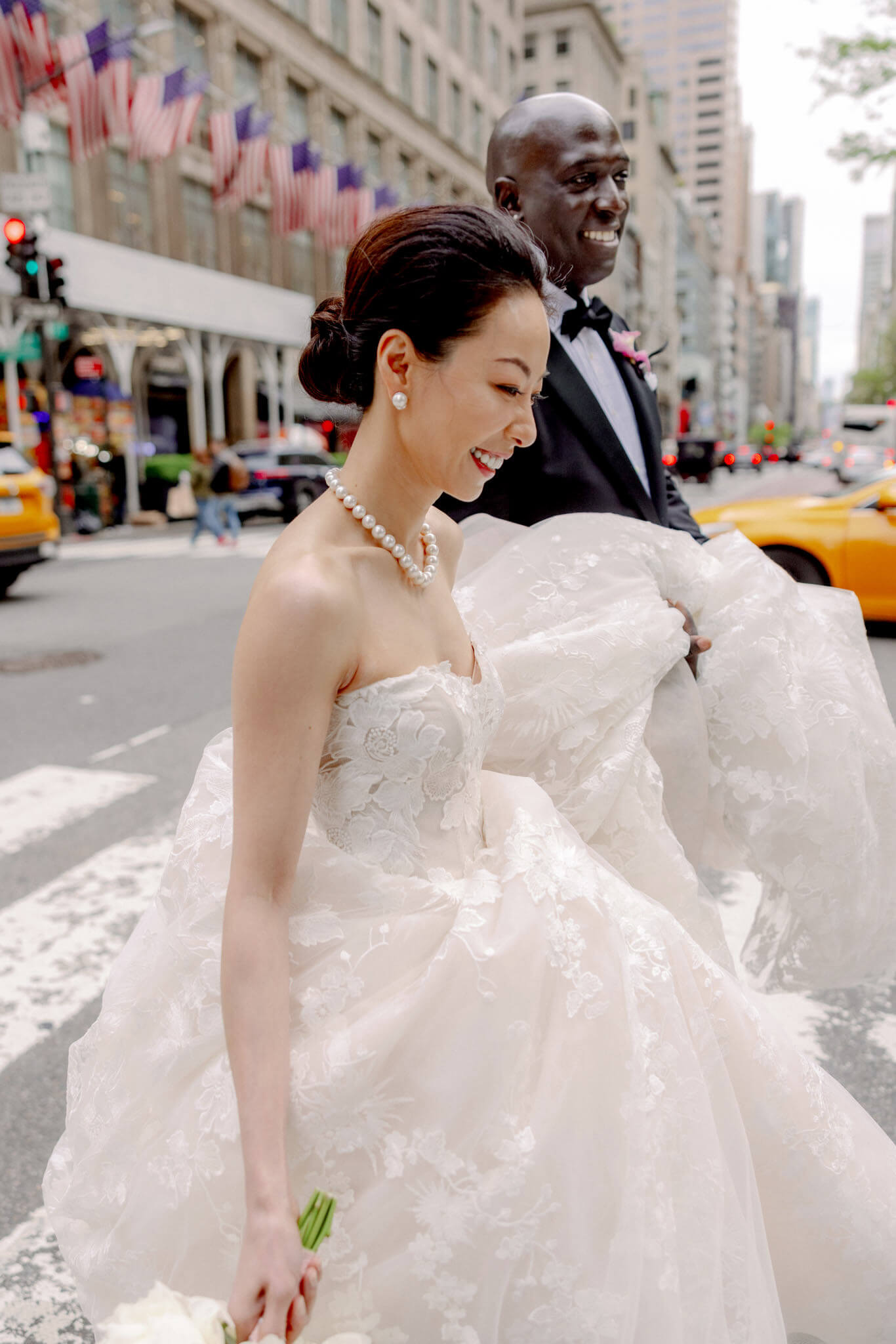 The bride and groom are crossing the streets of New York. Image by Jenny Fu Studio