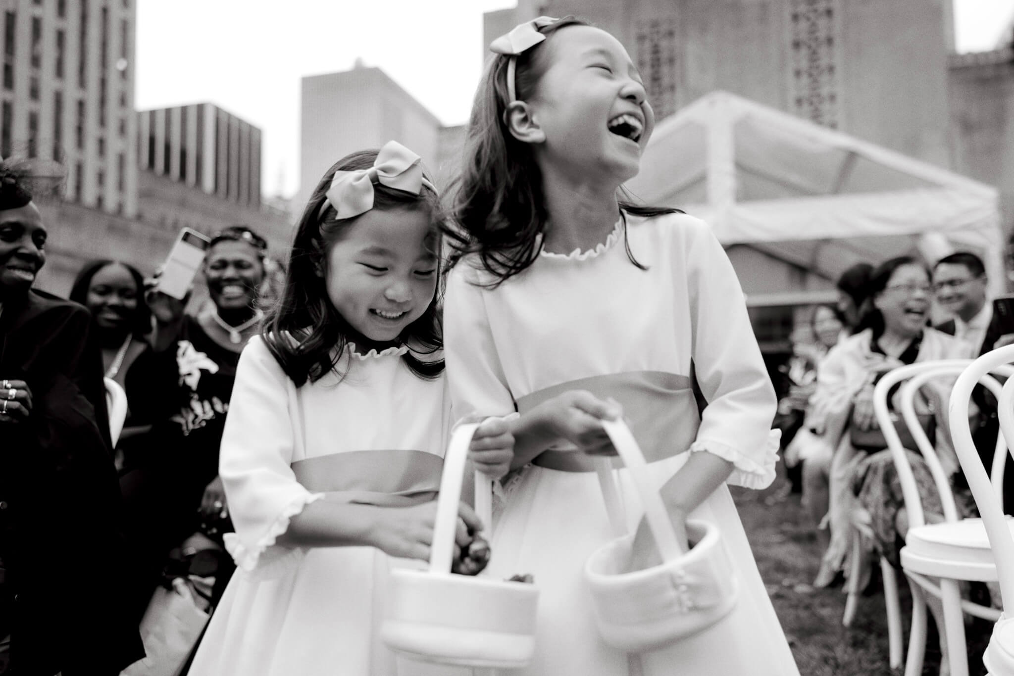 The flower girls are having fun while throwing flower petals at 620 Loft and Garden. Image by Jenny Fu Studio