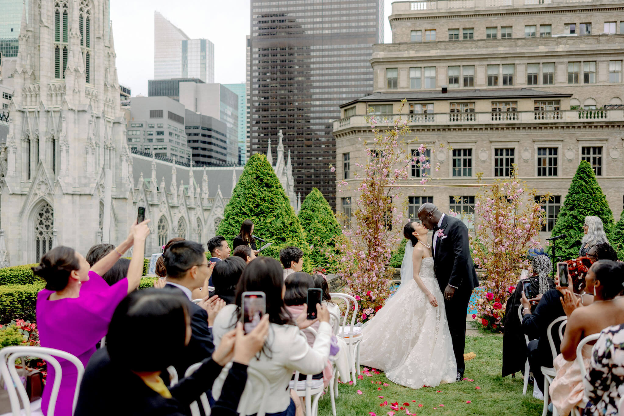 The newly-weds are kissing each other after the wedding ceremony at 620 Loft and Garden, NYC. Image by Jenny Fu Studio