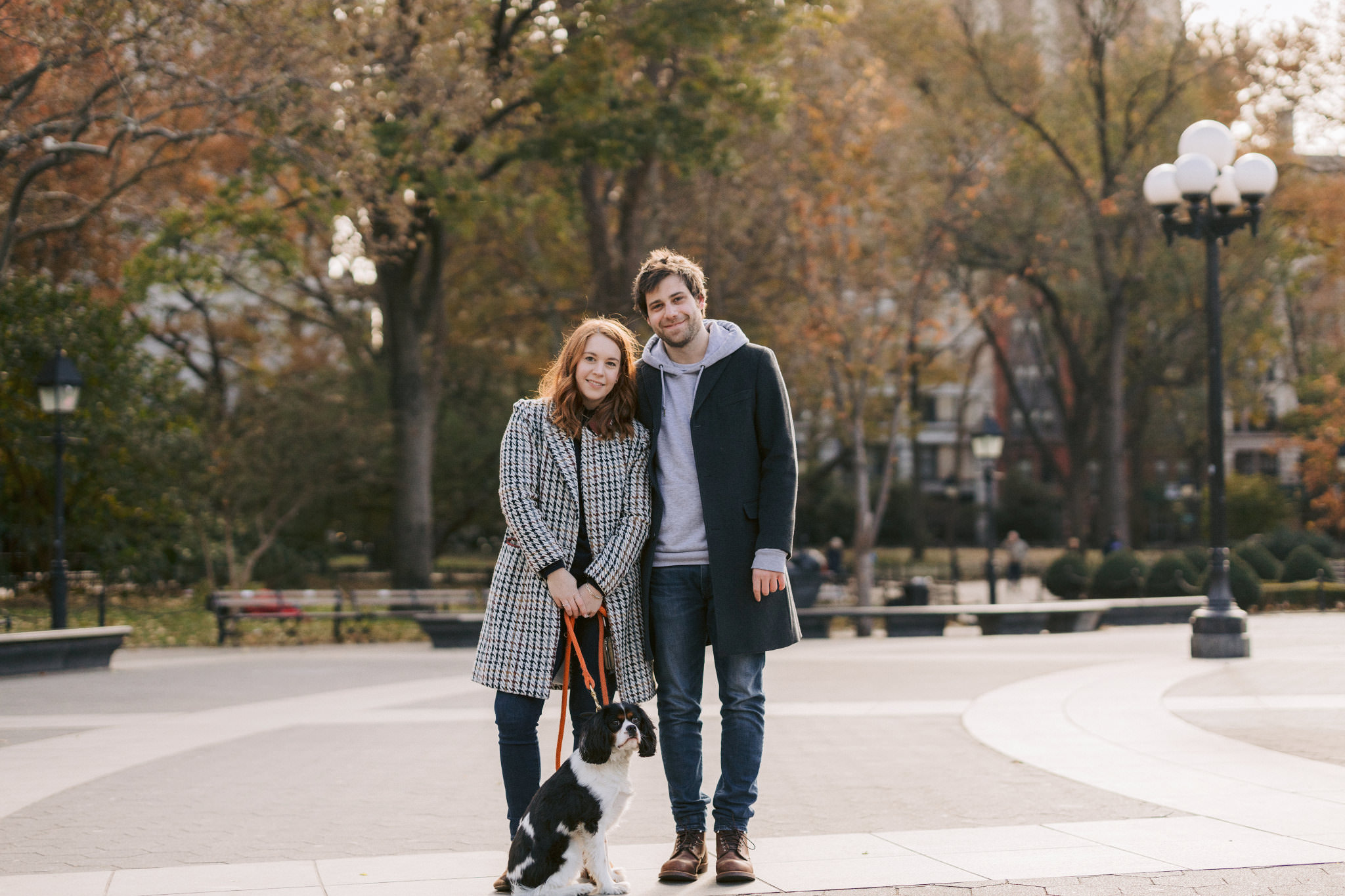 Editorial photo of the engaged couple with their pet at the park. Engagement session with pets photo by Jenny Fu Studio.