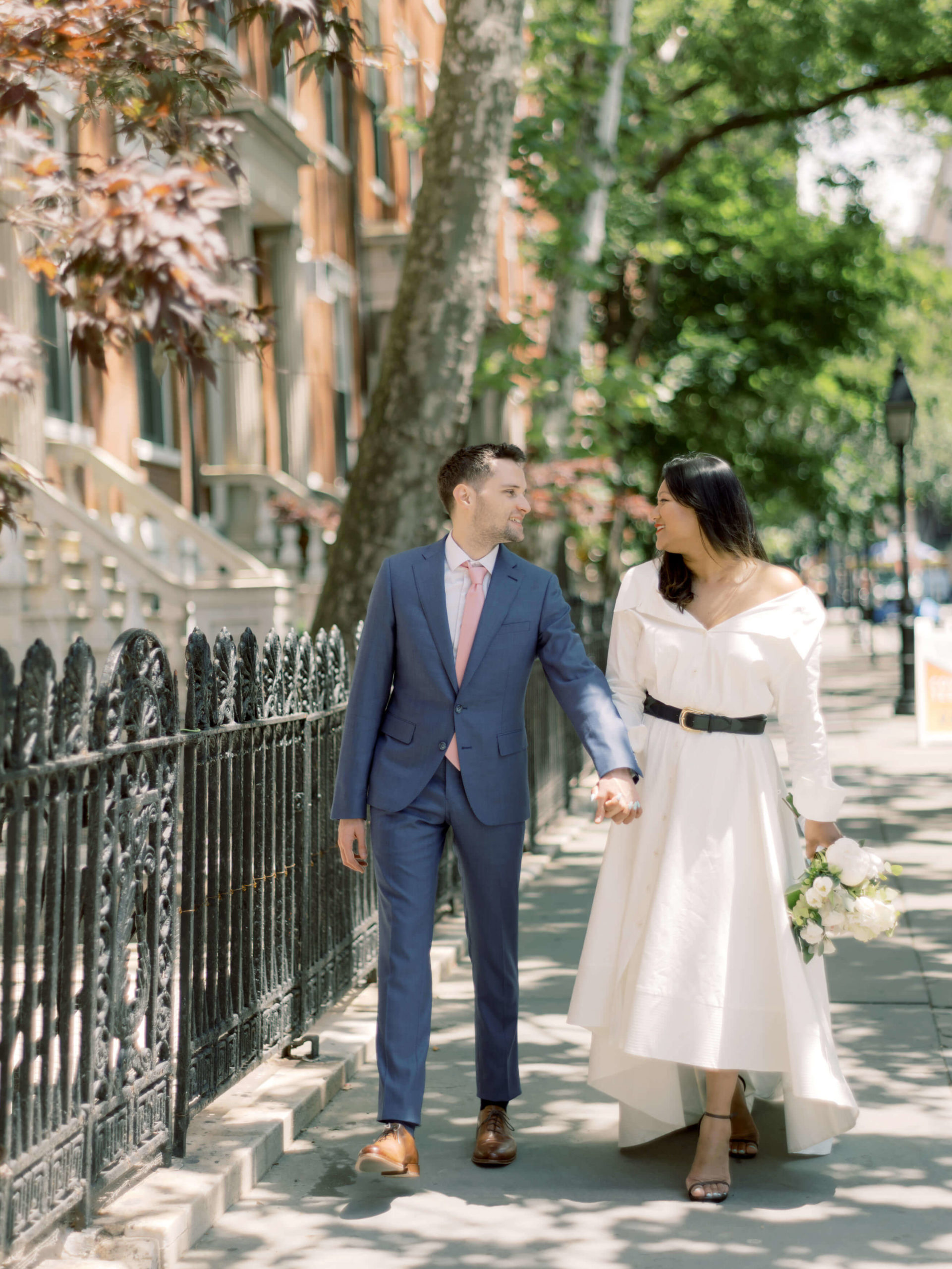 Editorial photo of the newlyweds walking in West Village. NYC City Hall wedding photos image by Jenny Fu Studio