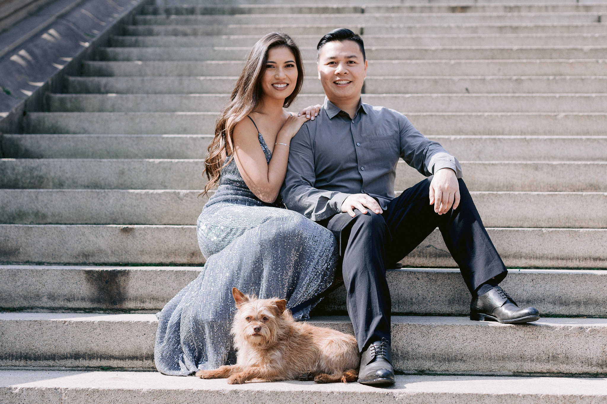 The engaged couple is at NY Central Park with their pet. Engagement session with pets photo by Jenny Fu Studio.