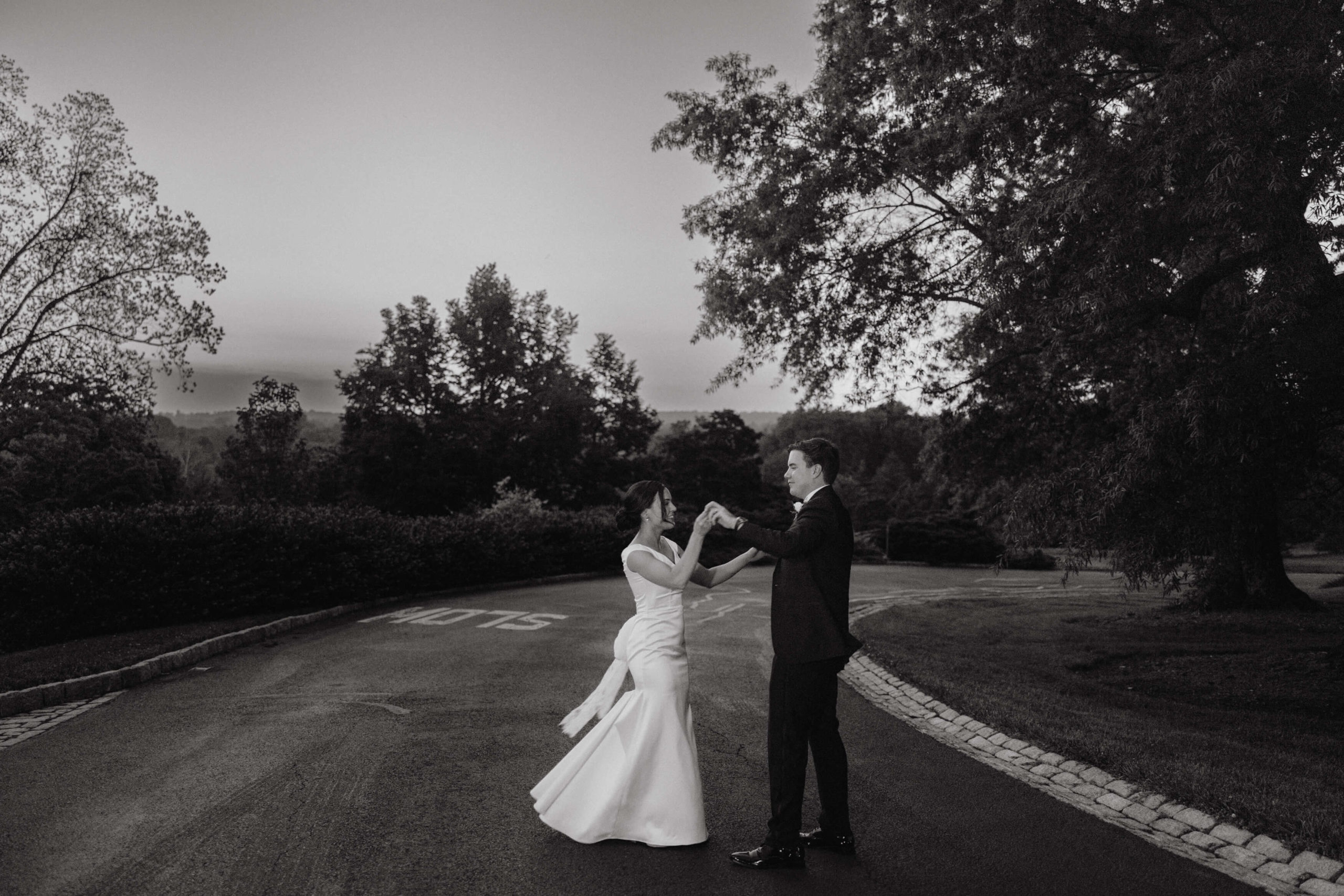 Editorial image of the newly-weds dancing in the middle of the road. Image by Jenny Fu Studio