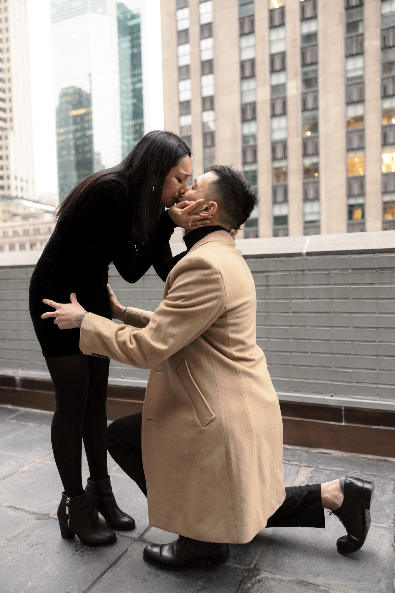 The woman is emotionally kissing her fiancé after she said yes. Proposal in NYC image by Jenny Fu Studio