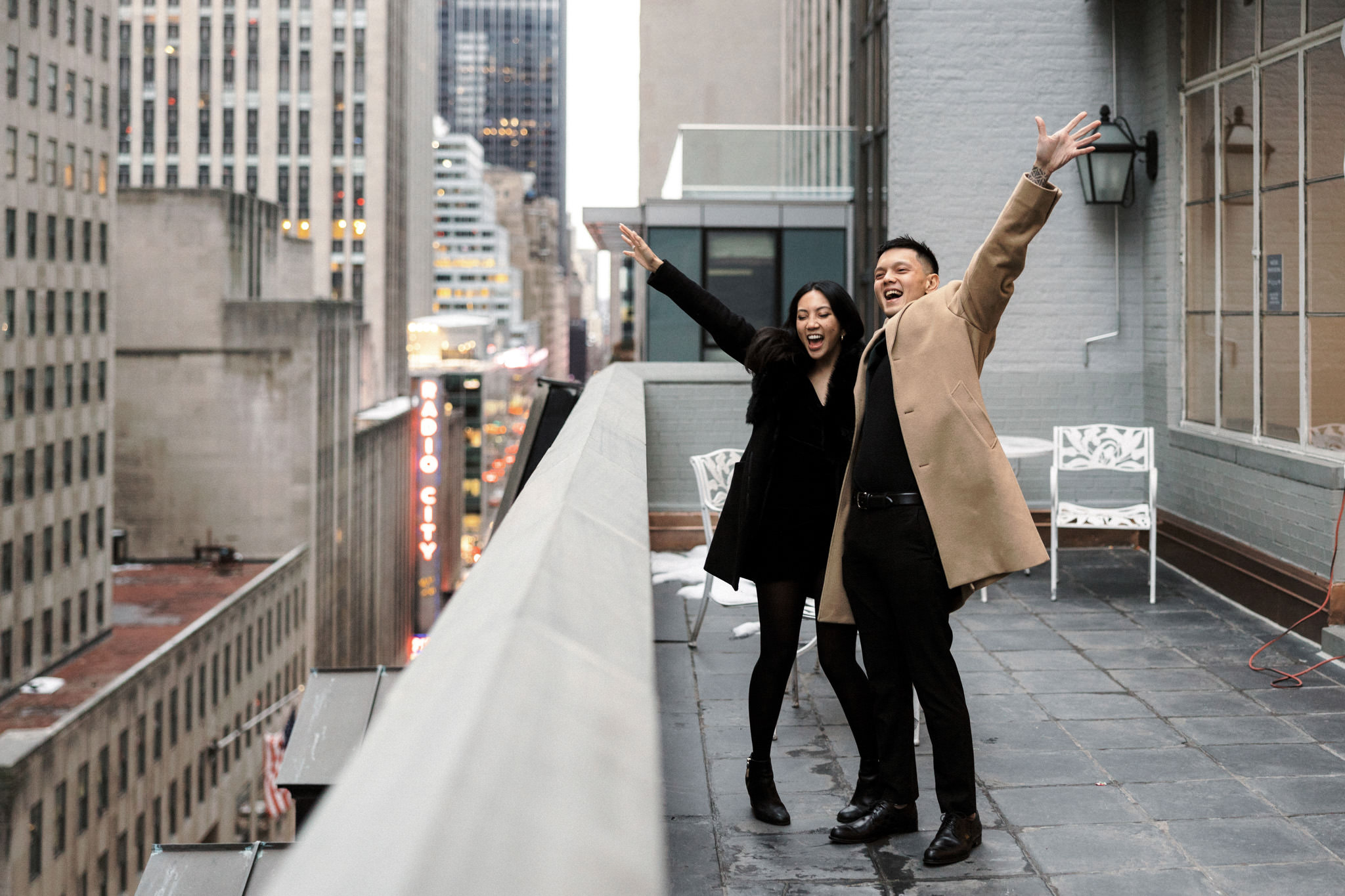 The couple is happily waving their hands in the air after the proposal. Proposal in NYC Image by Jenny Fu Studio 