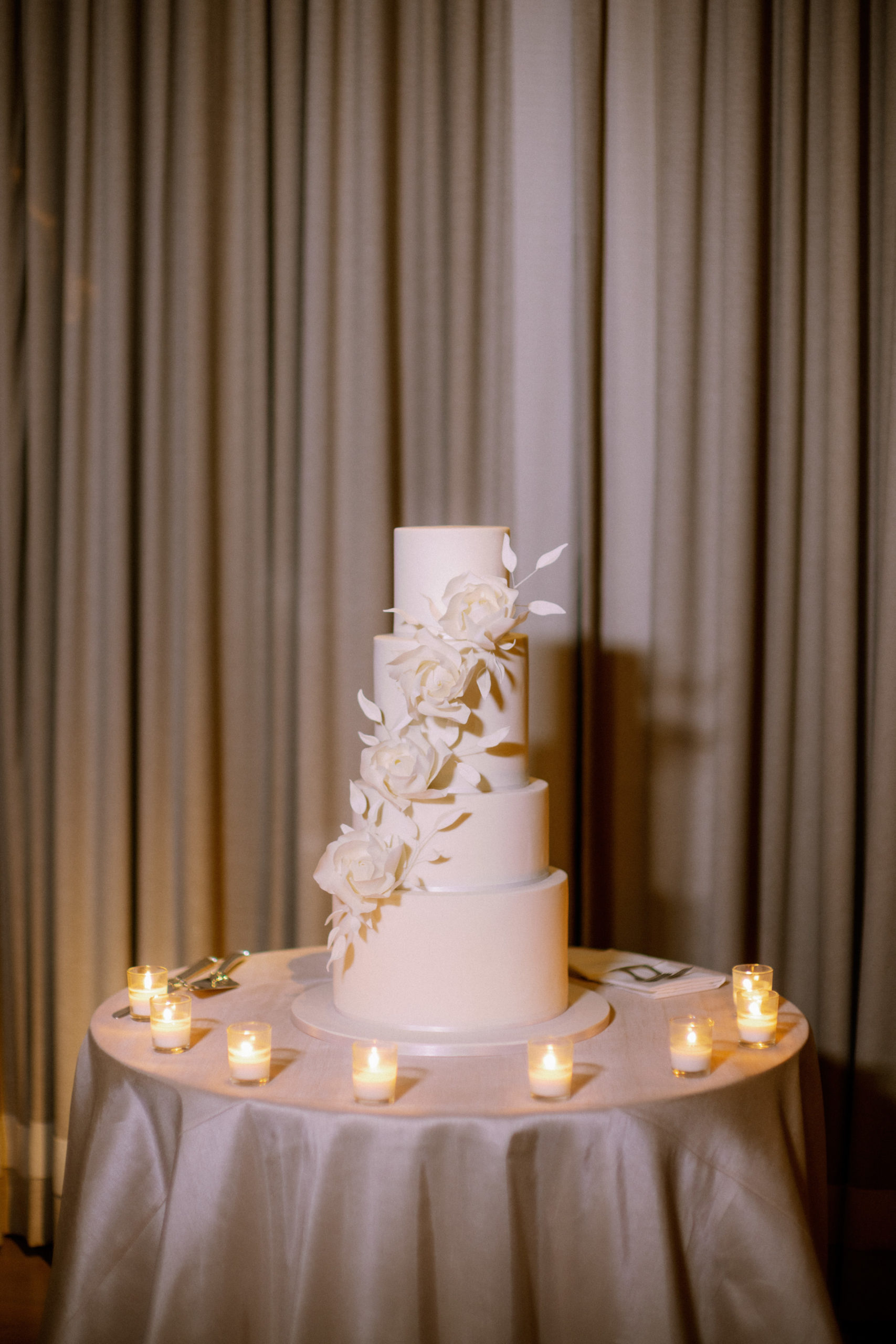 An elegant white monochrome wedding cake by Sweet Passion Cakery. Luxury wedding cake image by Jenny Fu Studio NYC