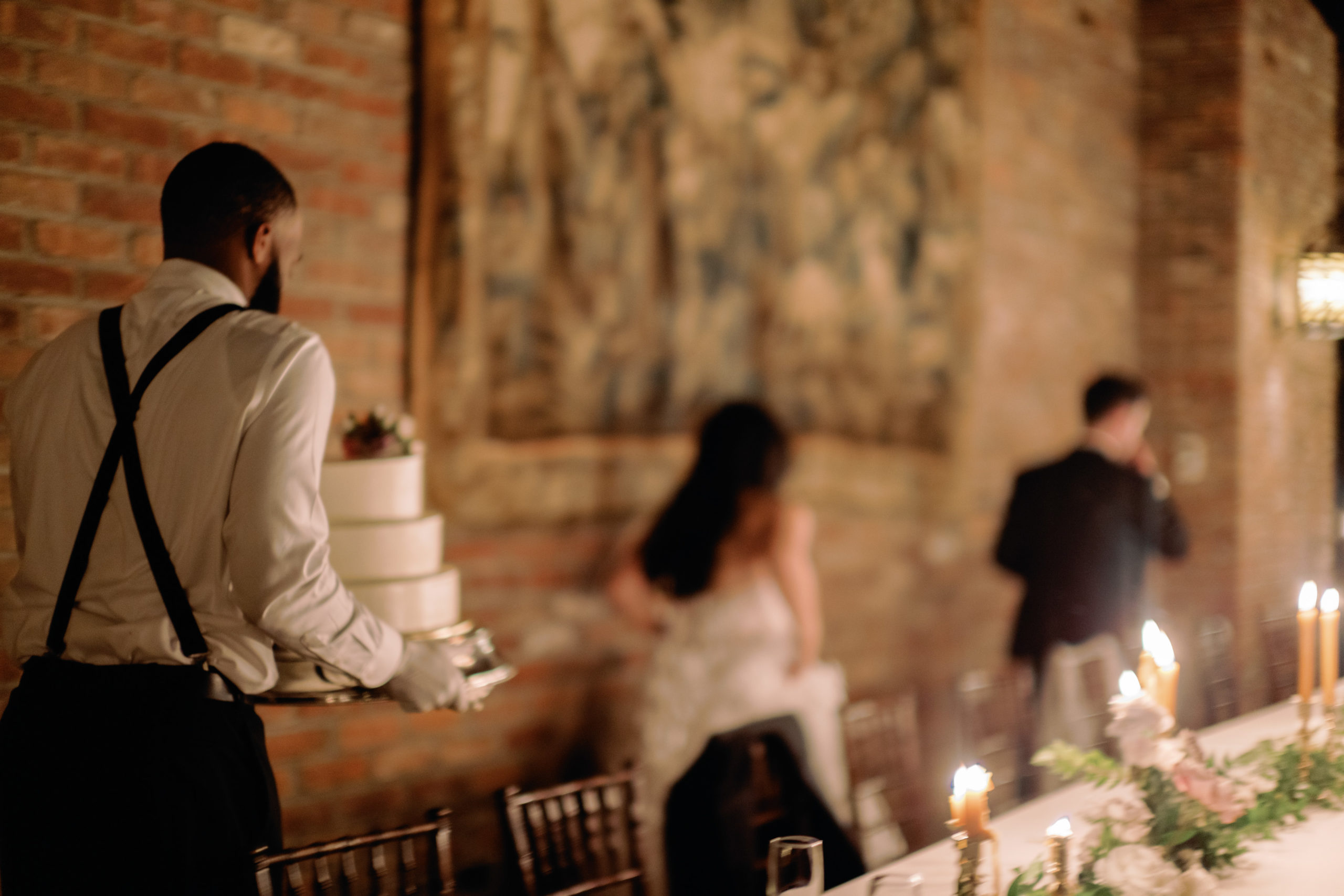 The wedding cake is being carried by hand. Image by Jenny Fu Studio NYC