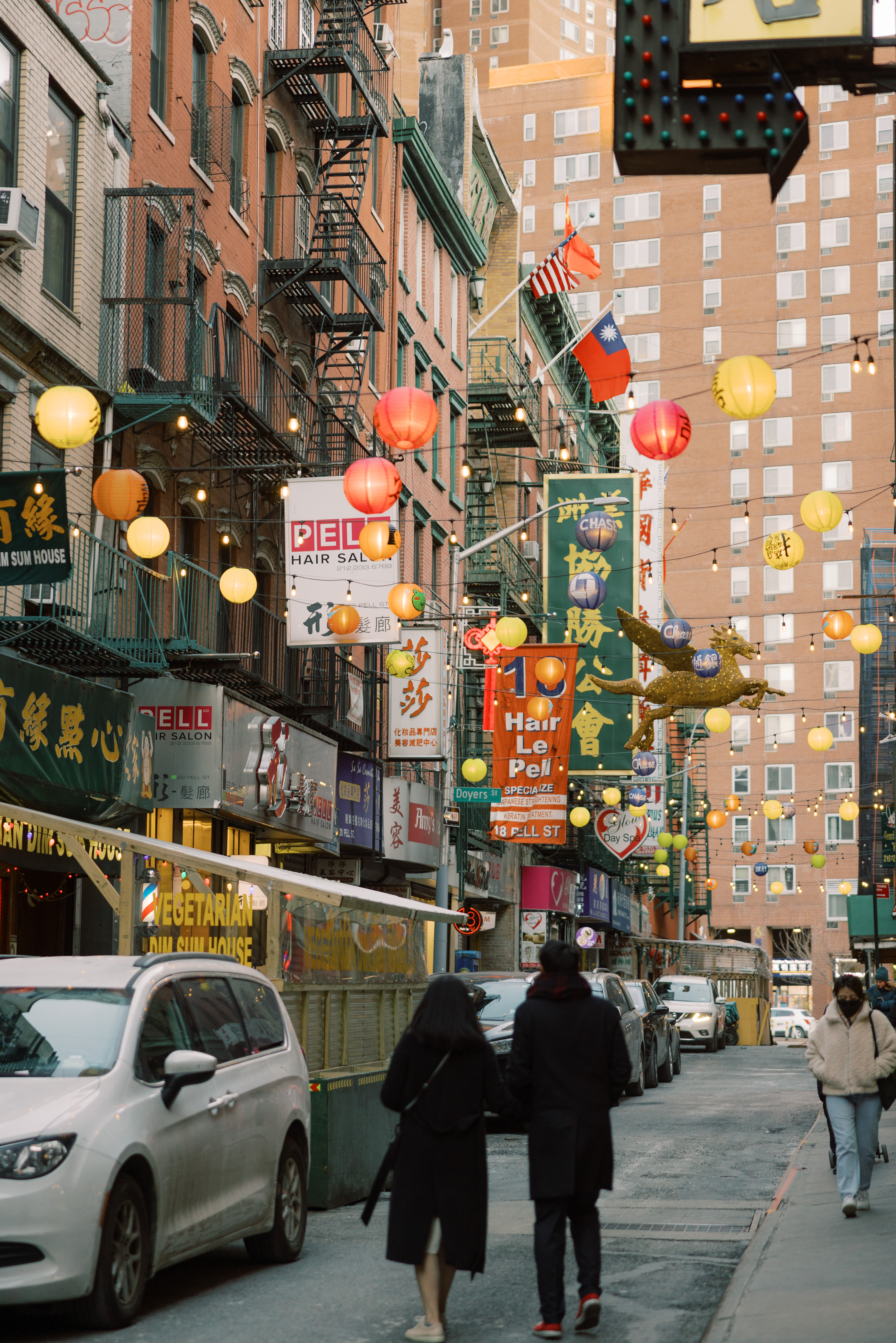 The newly-weds are walking in the colorful Chinatown in NYC. Image by Jenny Fu Studio
