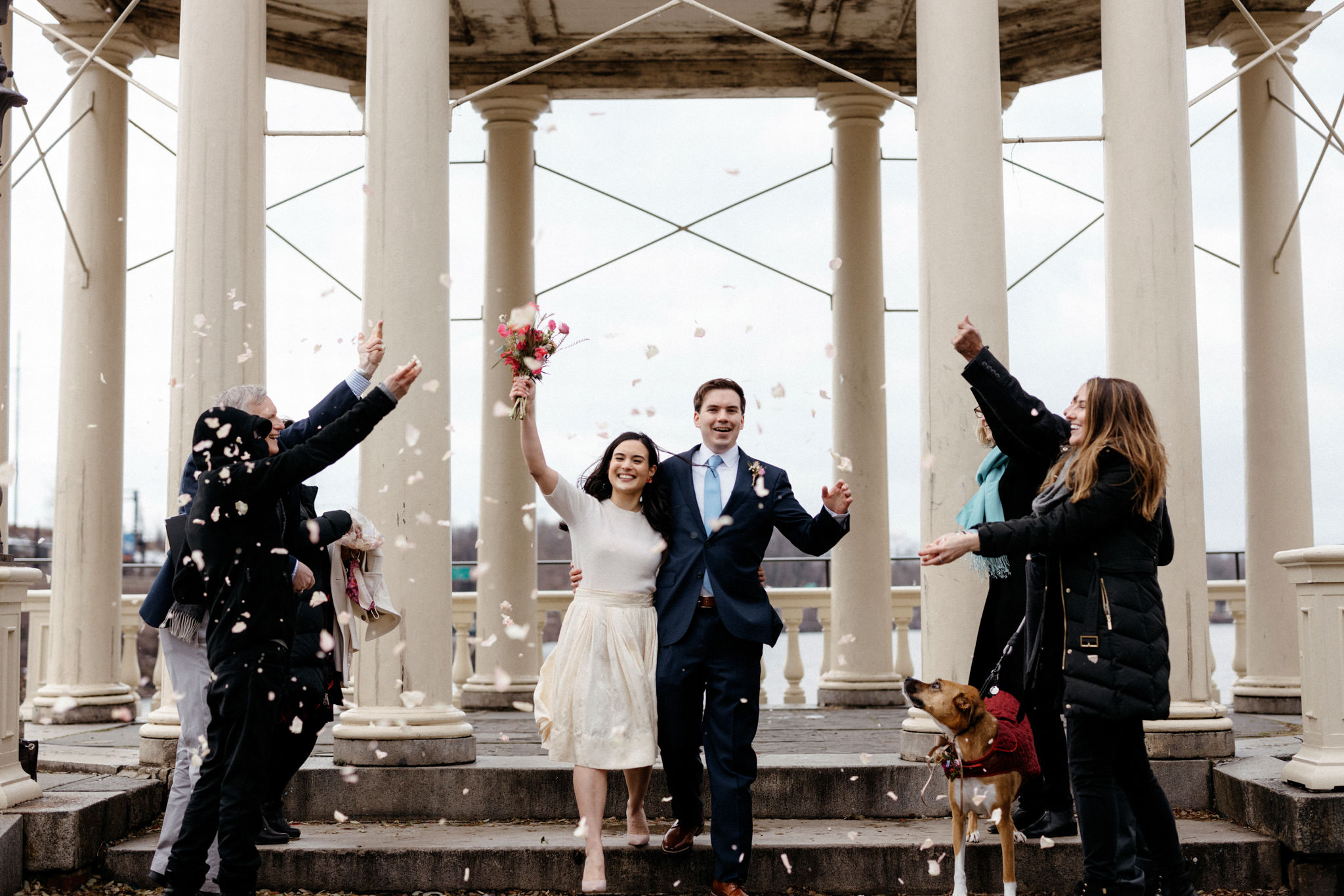 The bride and groom walk on the isle as the guests shower them with flower petals. Winter wedding venues image by Jenny Fu Studio
