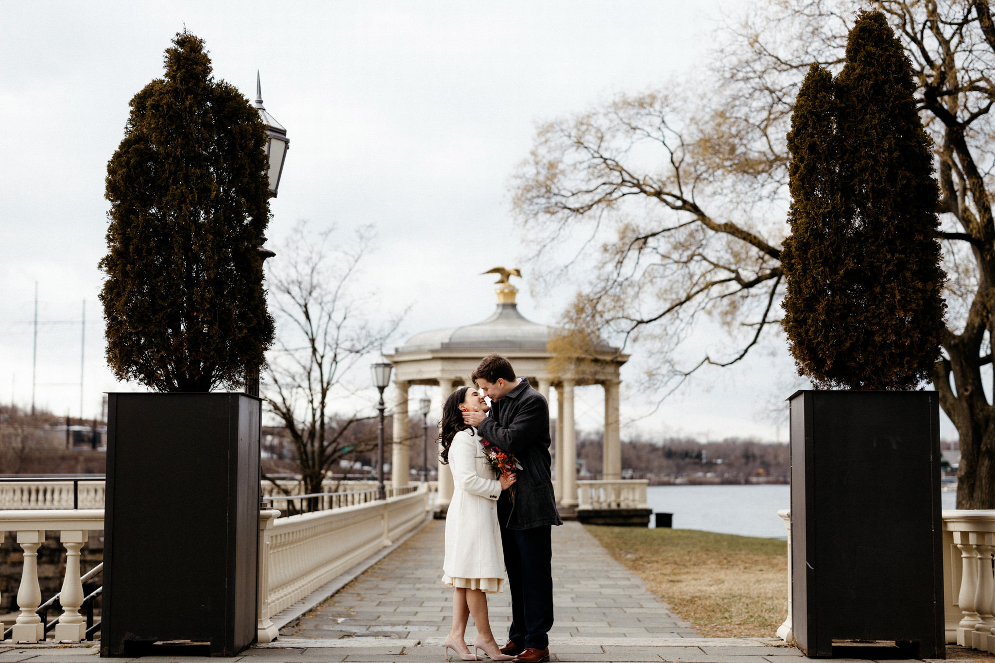 Outdoor photo of the newly-weds standing close to each other, about to kiss. Winter wedding venues image by Jenny Fu Studio