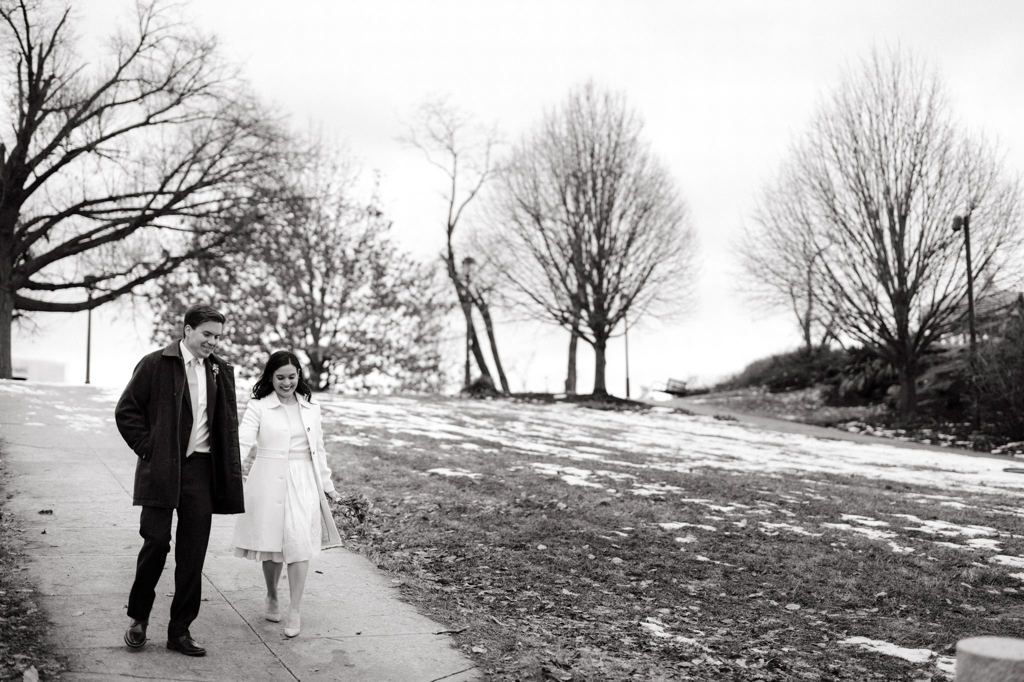 Editorial wedding image of the newly-weds outdoors in the snow. Winter wedding venues image by Jenny Fu Studio