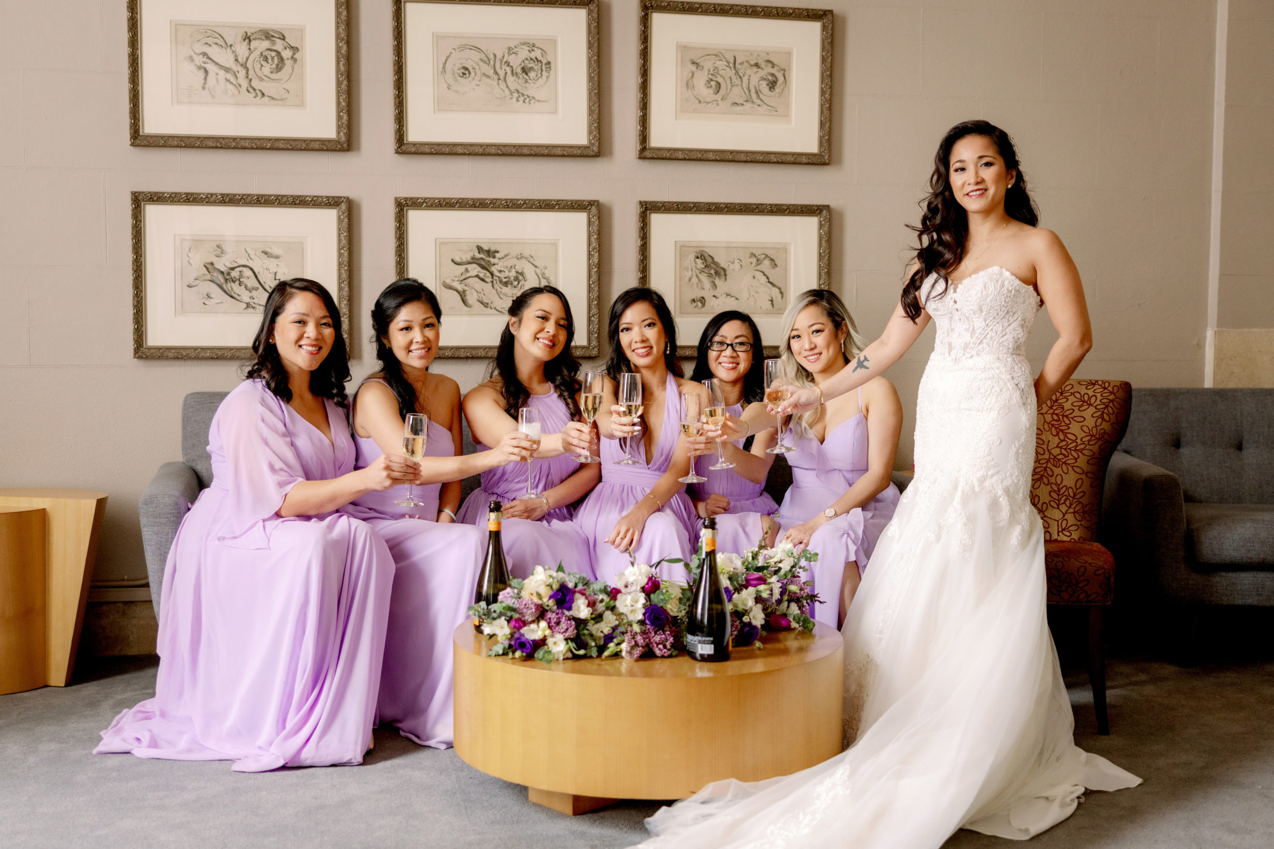 The bride and the bridesmaids are holding champagne bottles. Luxury wedding photography image by Jenny Fu Studio.