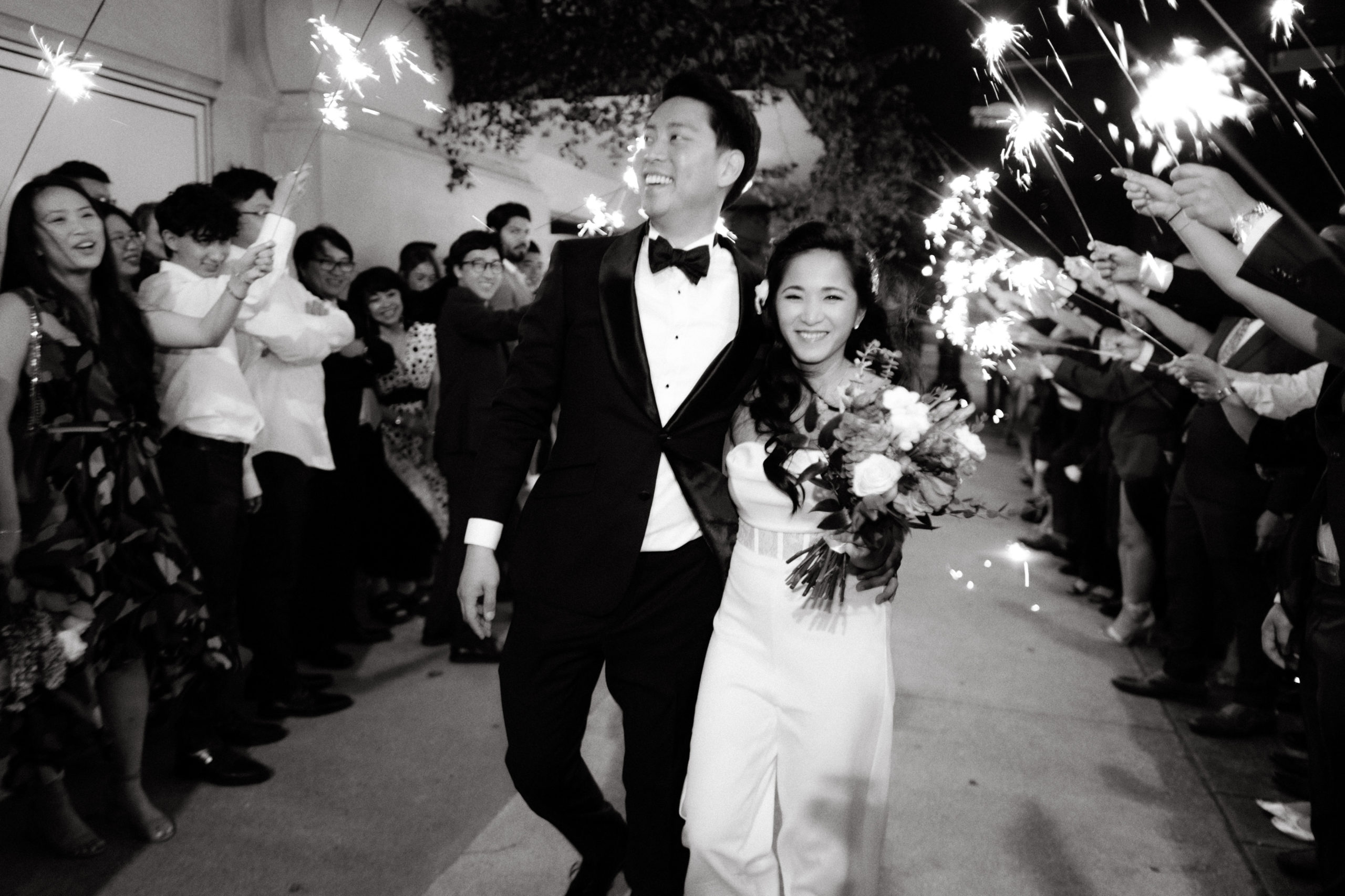 Editorial photo of the bride and groom as they exit the wedding venue. Image by Jenny Fu Studio 