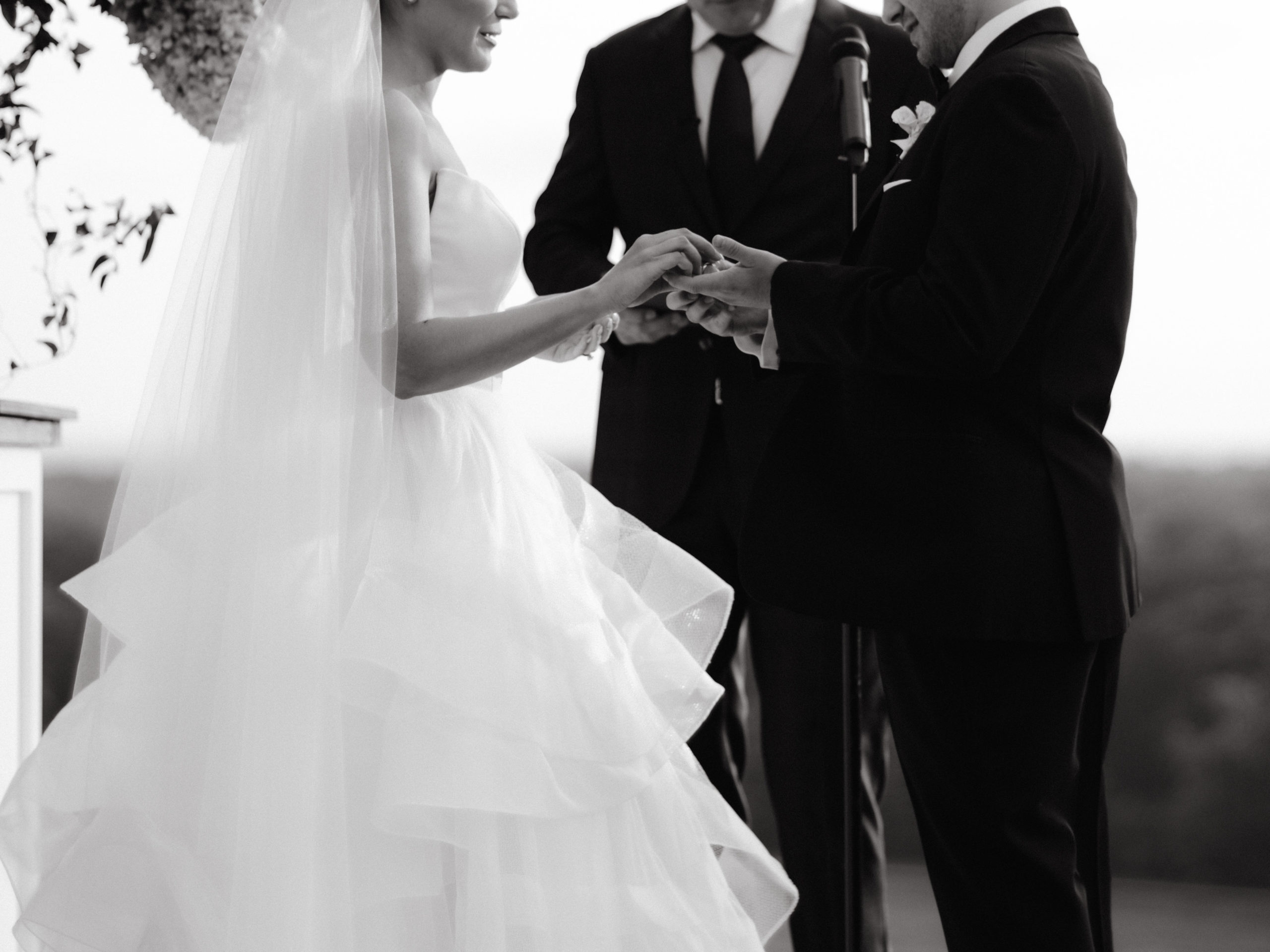 Black and white photo of the wedding bride and groom saying vows. NYC wedding photographer cost image by Jenny Fu Studio.