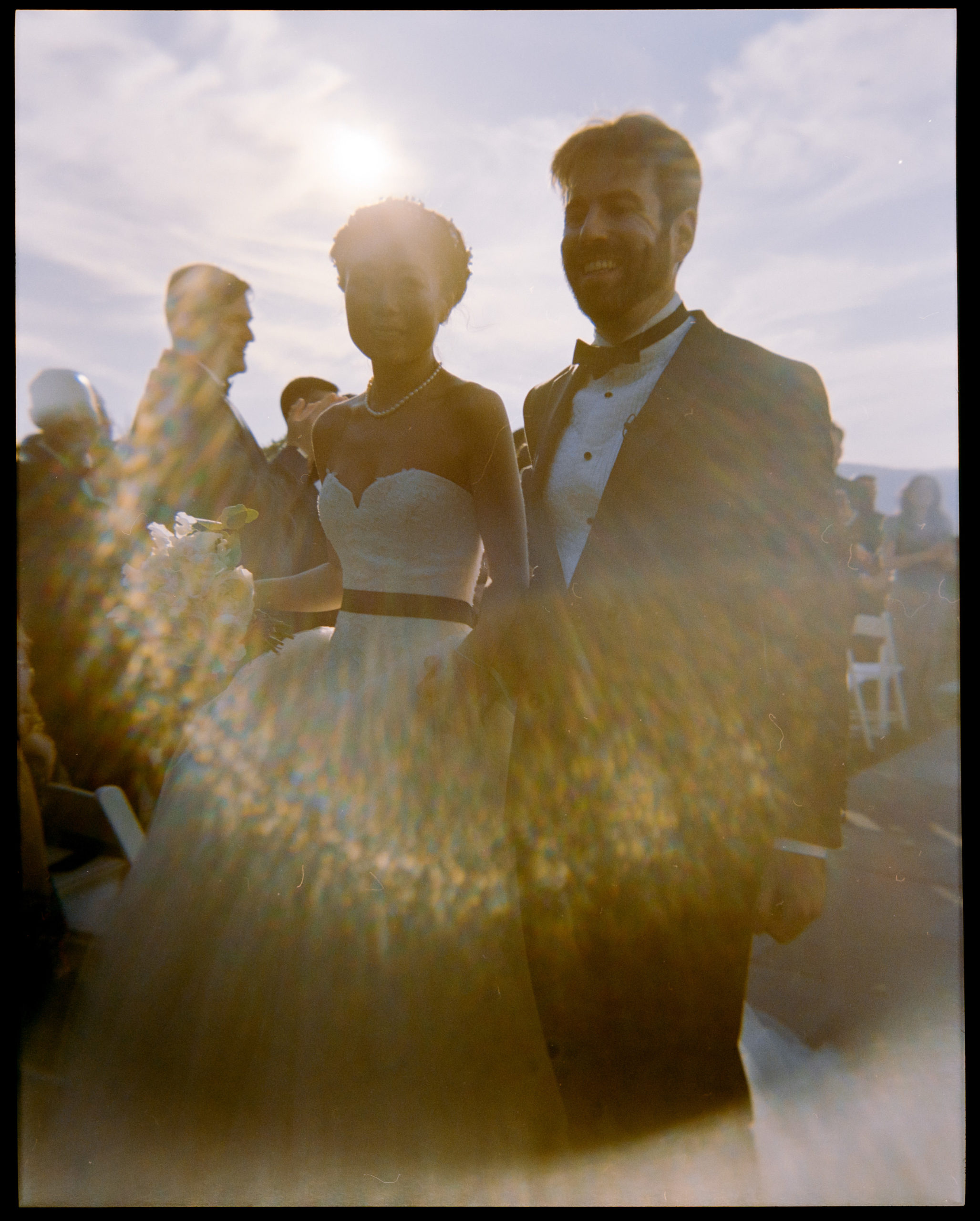 The newlyweds are smiling at The Garrison, New York. Film photography image by Jenny Fu Studio