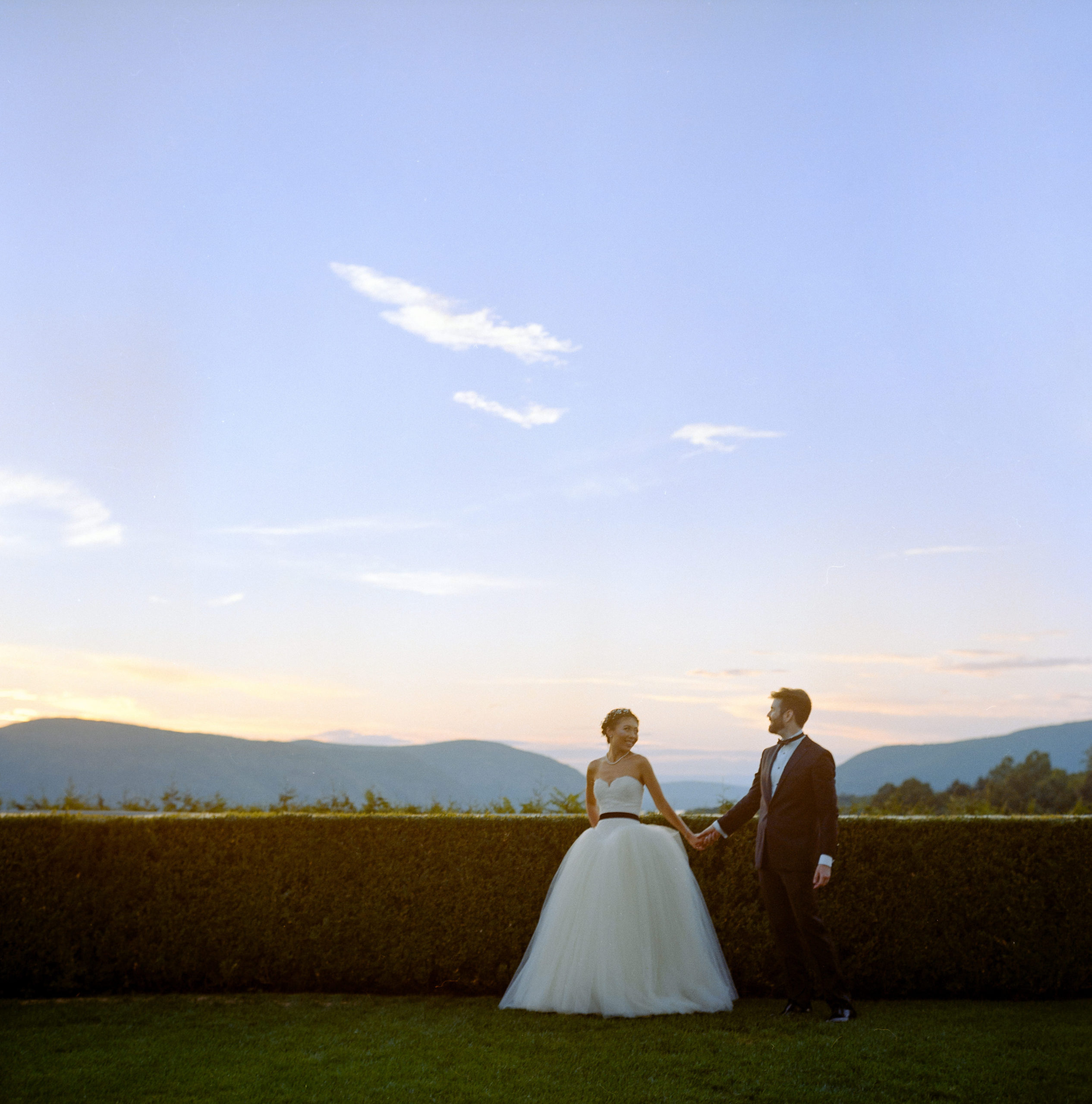 Sunset photo of the bride and groom in a garden. Film photography image by Jenny Fu Studio