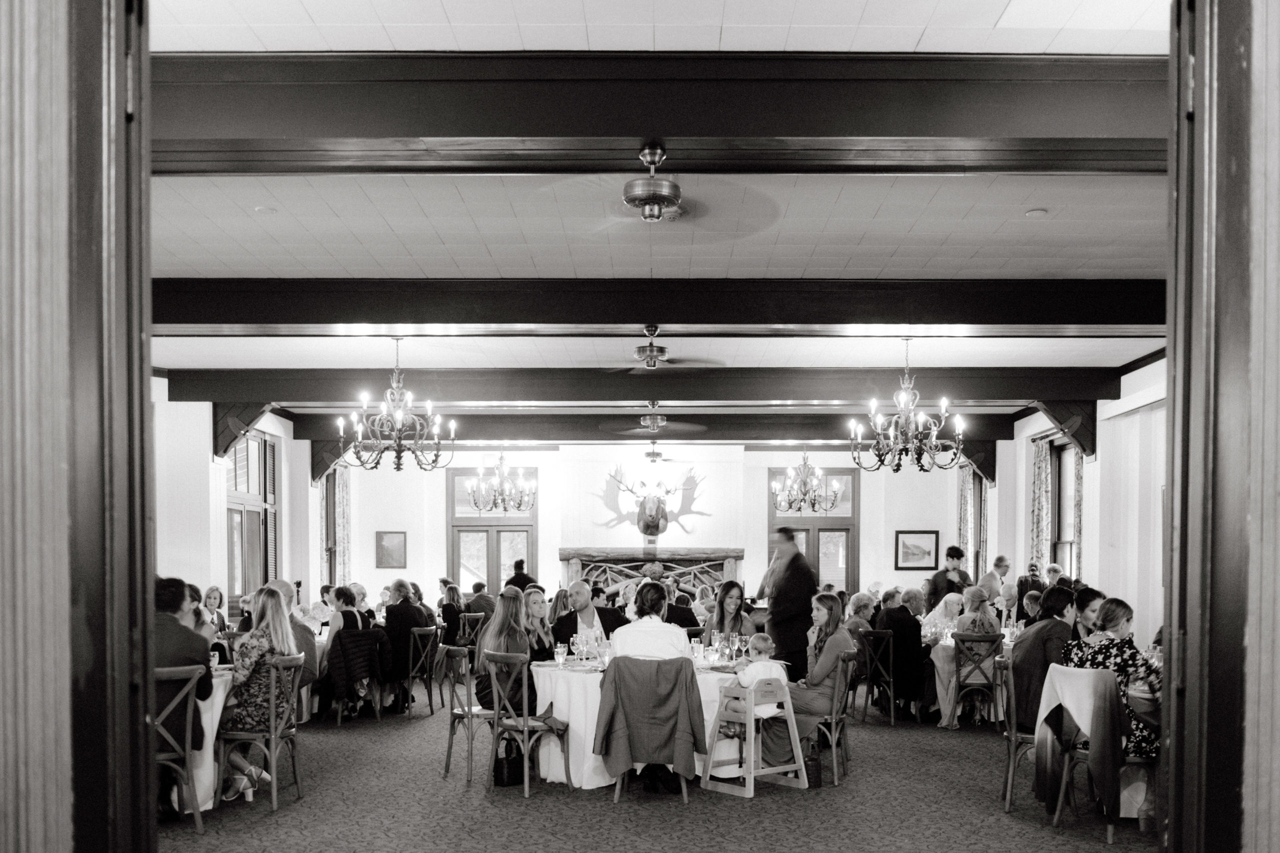 Guests are chatting at a welcome dinner in The Ausable Club. Image by Jenny Fu Studio