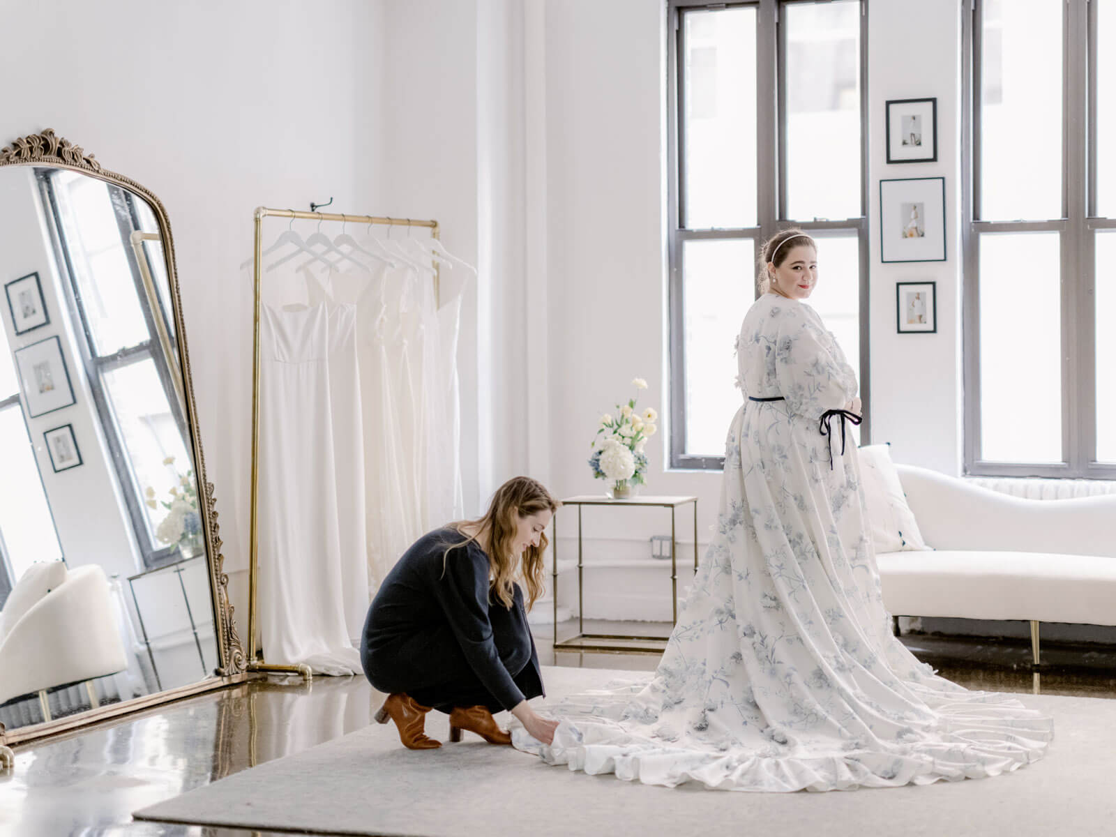 Alexandra Grecco is fixing the hemline of a wedding dress she made for her sister. Image by Jenny Fu Studio