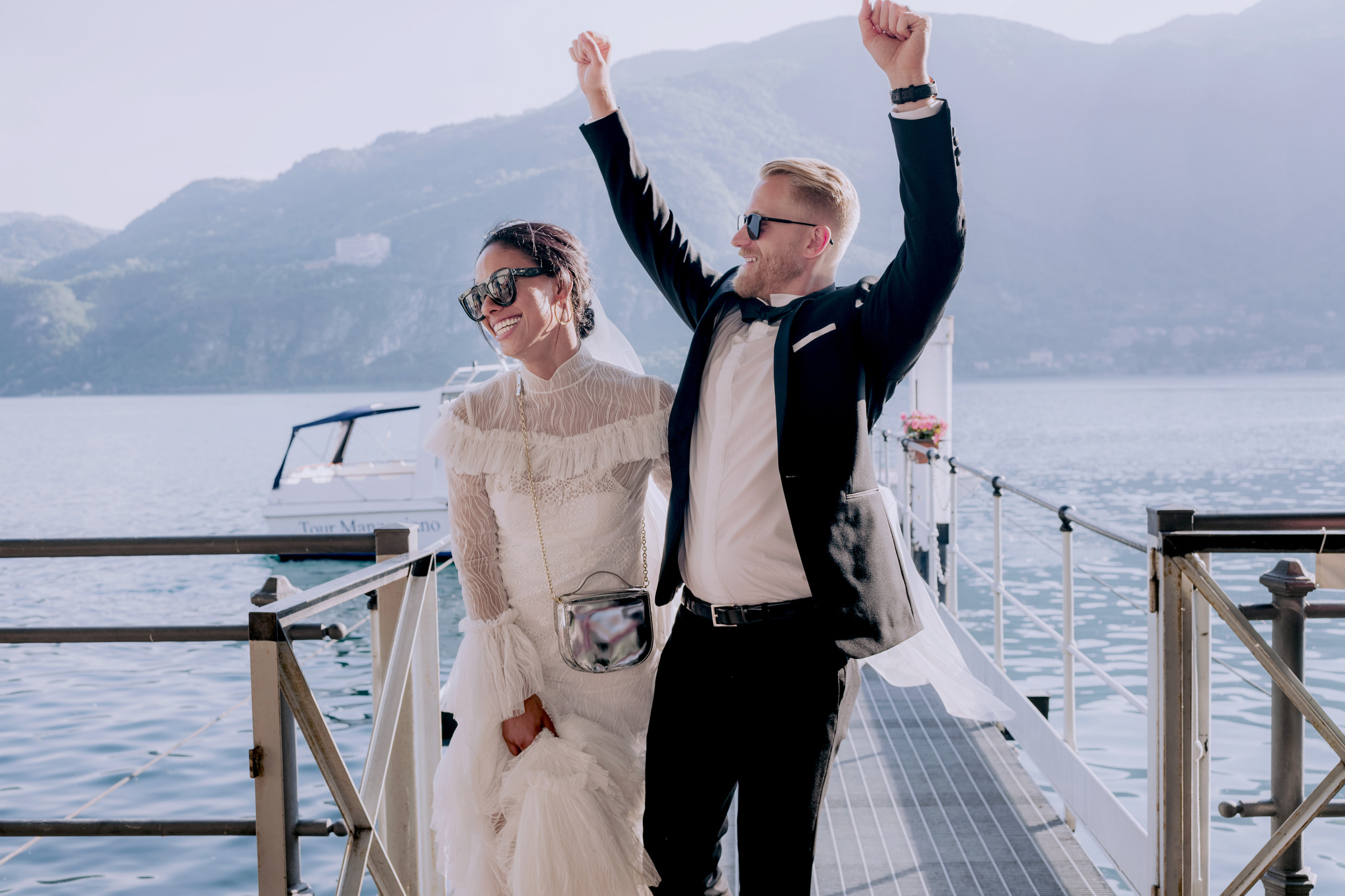 Editorial image of the bride and groom with Italian lake in the background. Destination Image by Jenny Fu Studio