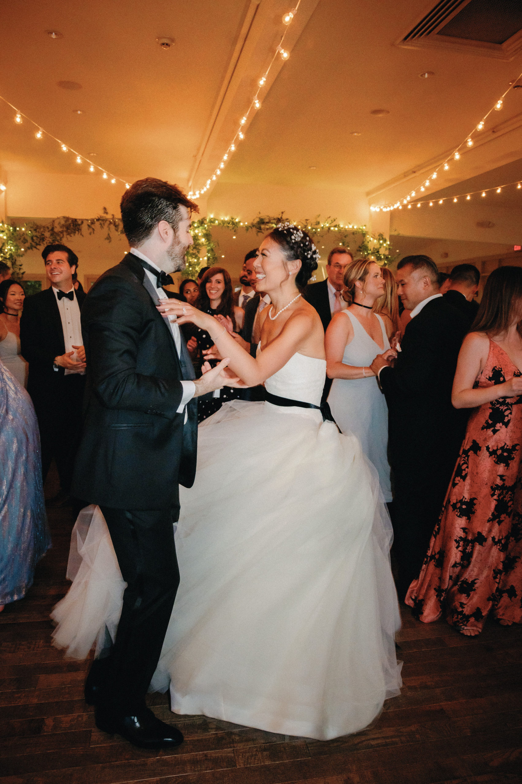 The bride and groom are happily dancing with the guests. Image by Jenny Fu Studio