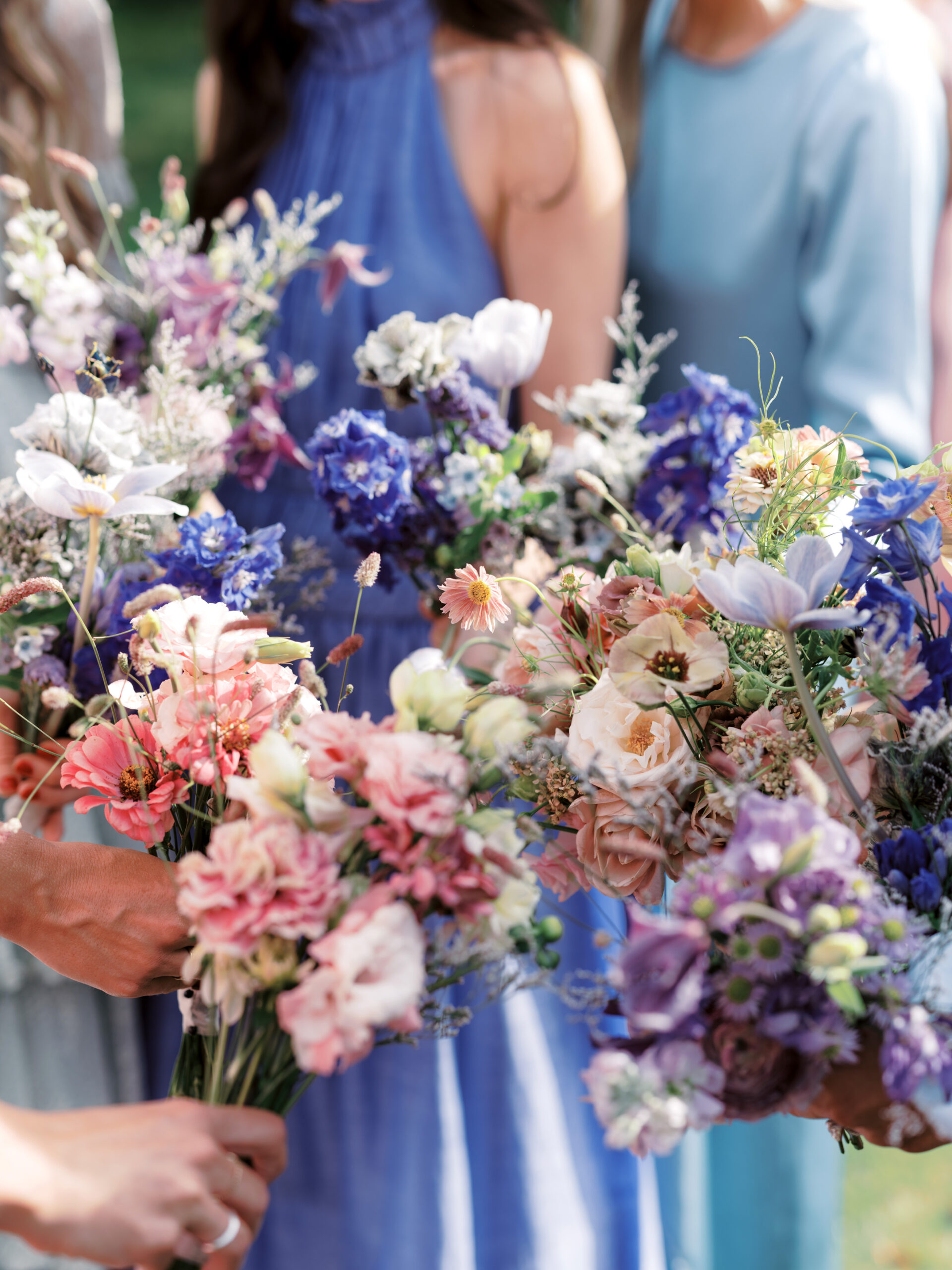 The bridesmaids' pretty flowers in shades of blue, pink and purple. Upstate New York luxury wedding image by Jenny Fu Studio.