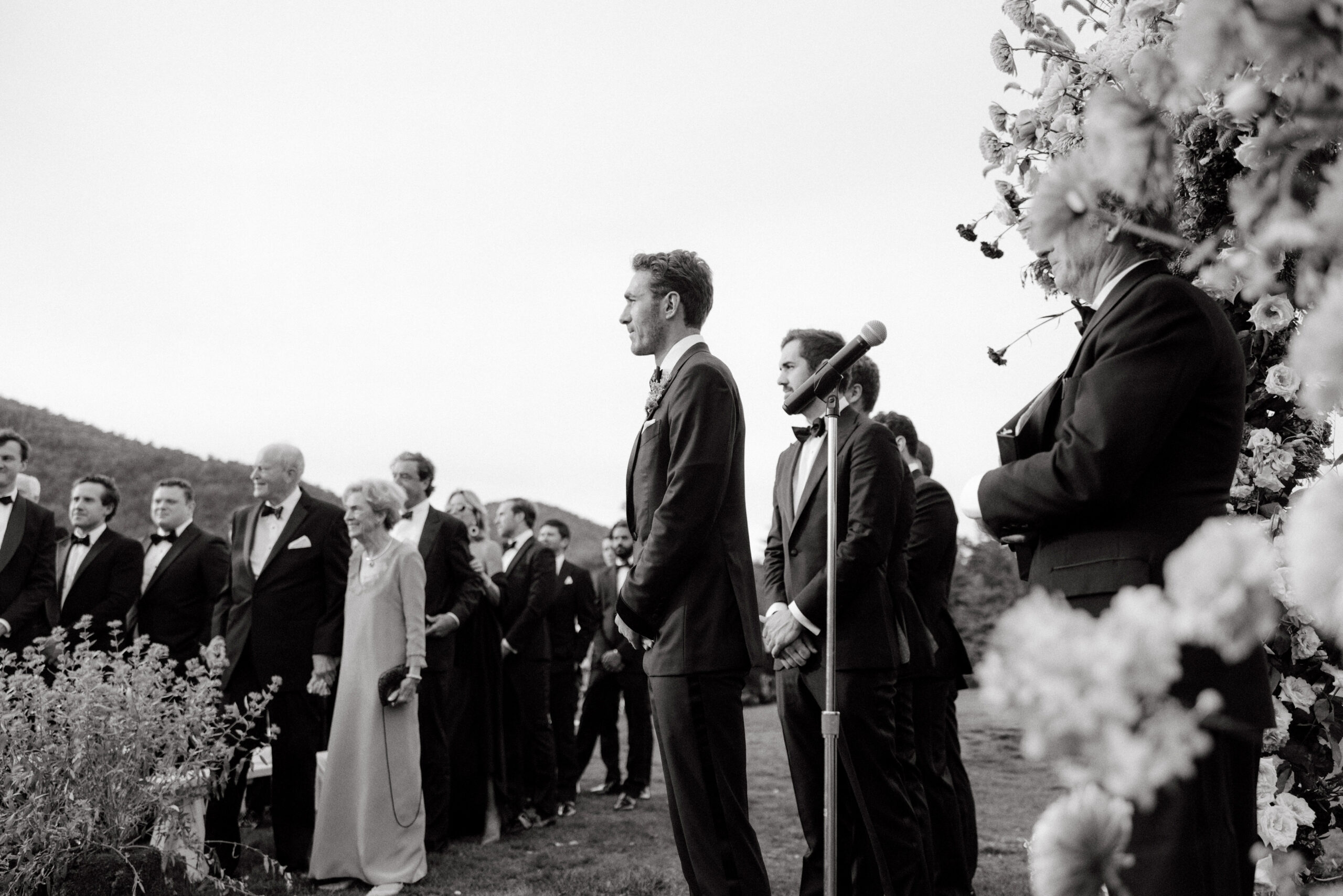 Editorial image of the groom watching the bride go down the aisle. Upstate New York luxury wedding image by Jenny Fu Studio.