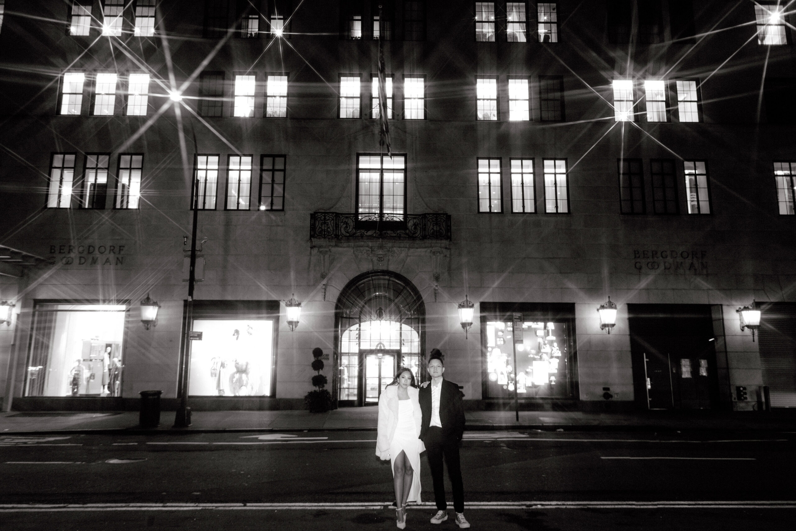 Black and white photo of the couple in front of Bergdorf Goodman Building NYC. Engagement photos image by Jenny Fu Studio