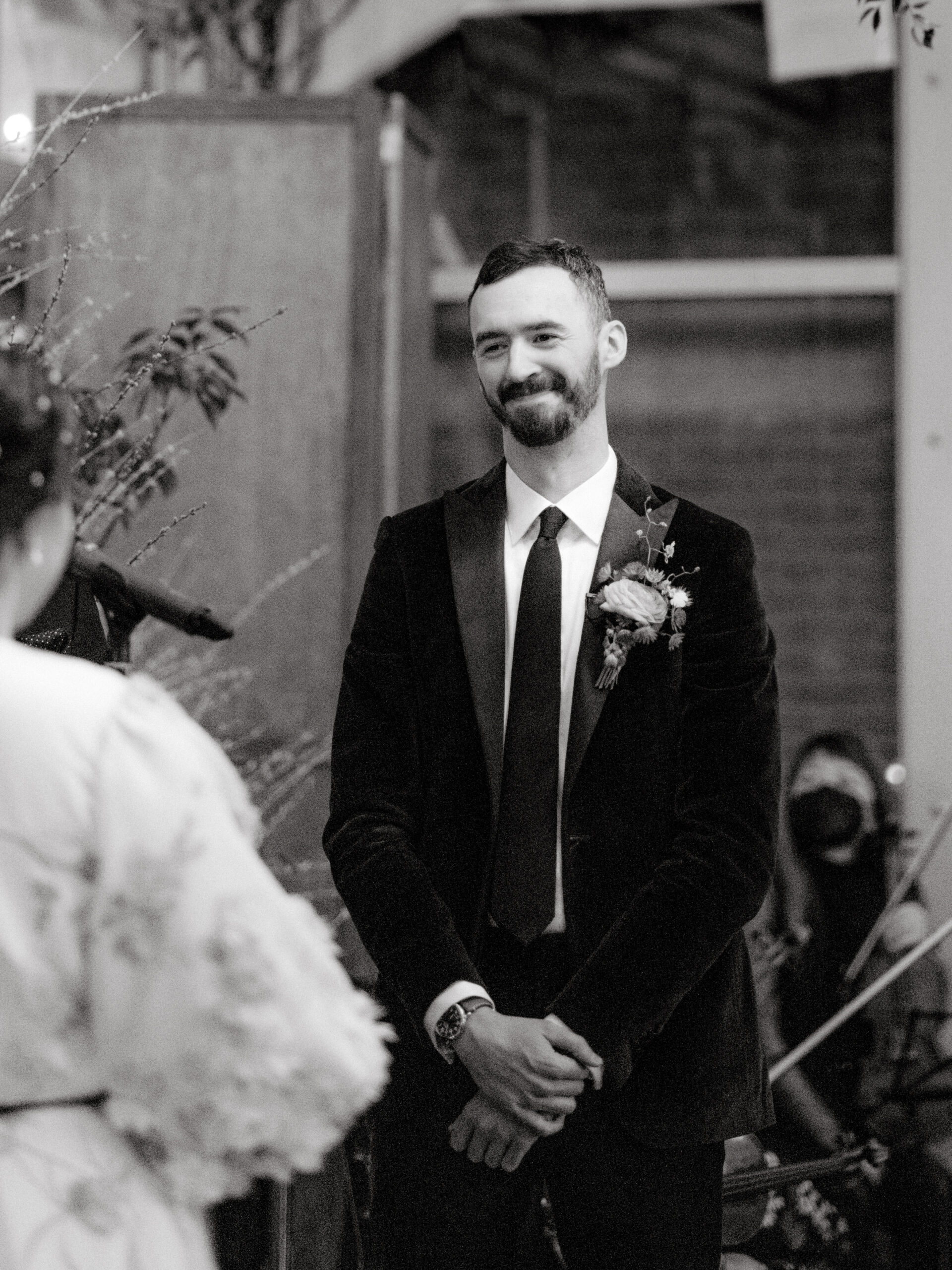 Editorial image of the groom happily looking at his bride while walking down the aisle. Capturing emotions image by Jenny Fu Studio