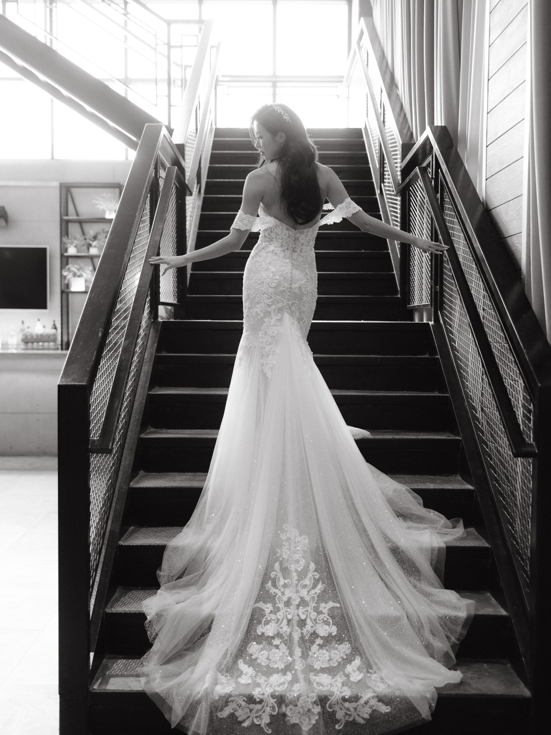 Editorial photo of the bride climbing up the stairs. 2023 wedding dress image by Jenny Fu Studio