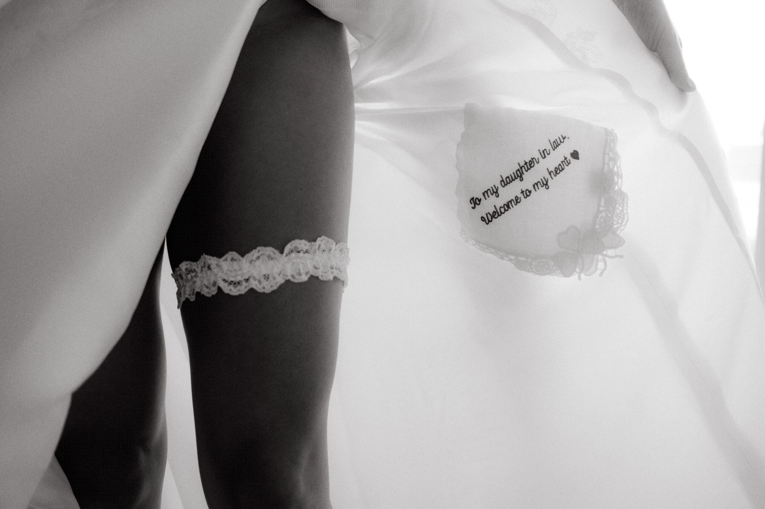 Black and white photo of the bride's garter. Image by Jenny Fu Studio NYC