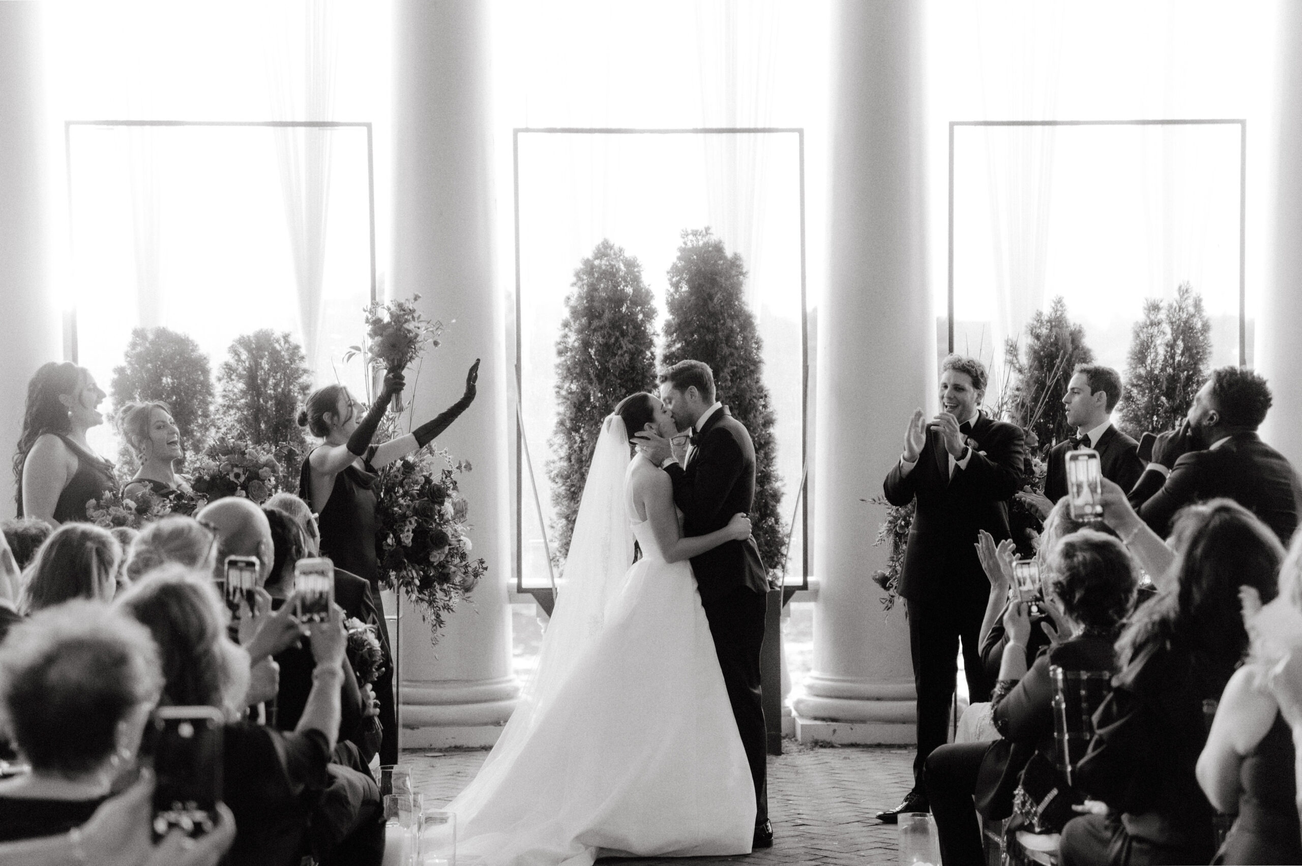 Black and white image of the newlywed's first kiss. Image by Jenny Fu Studio