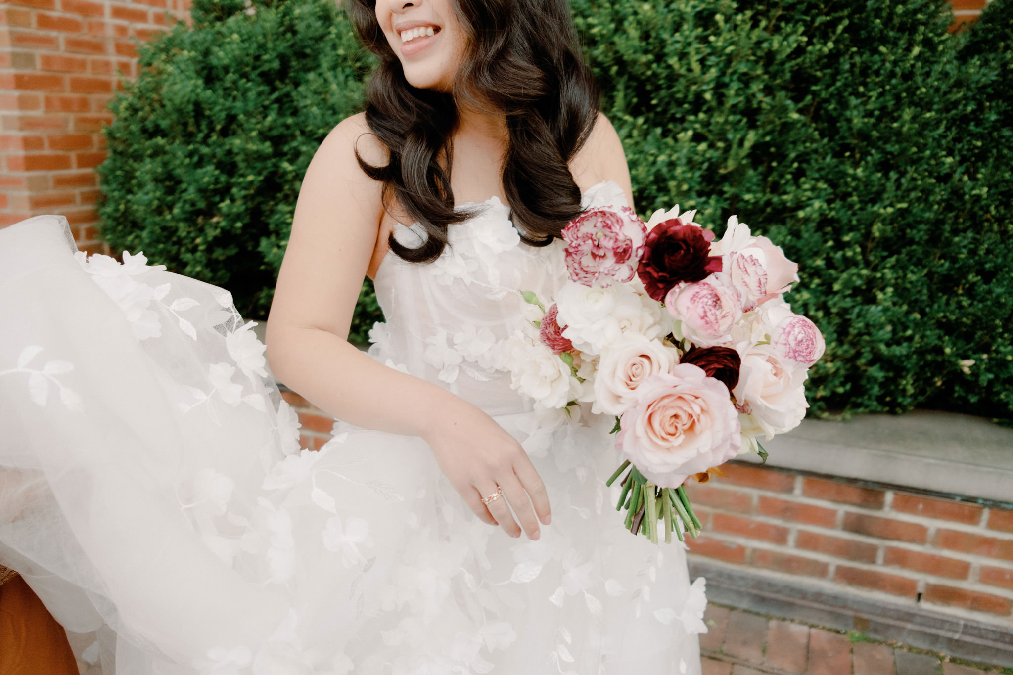 The bride is smiling while holding her pretty bouquet. 2023 wedding dress image by Jenny Fu Studio