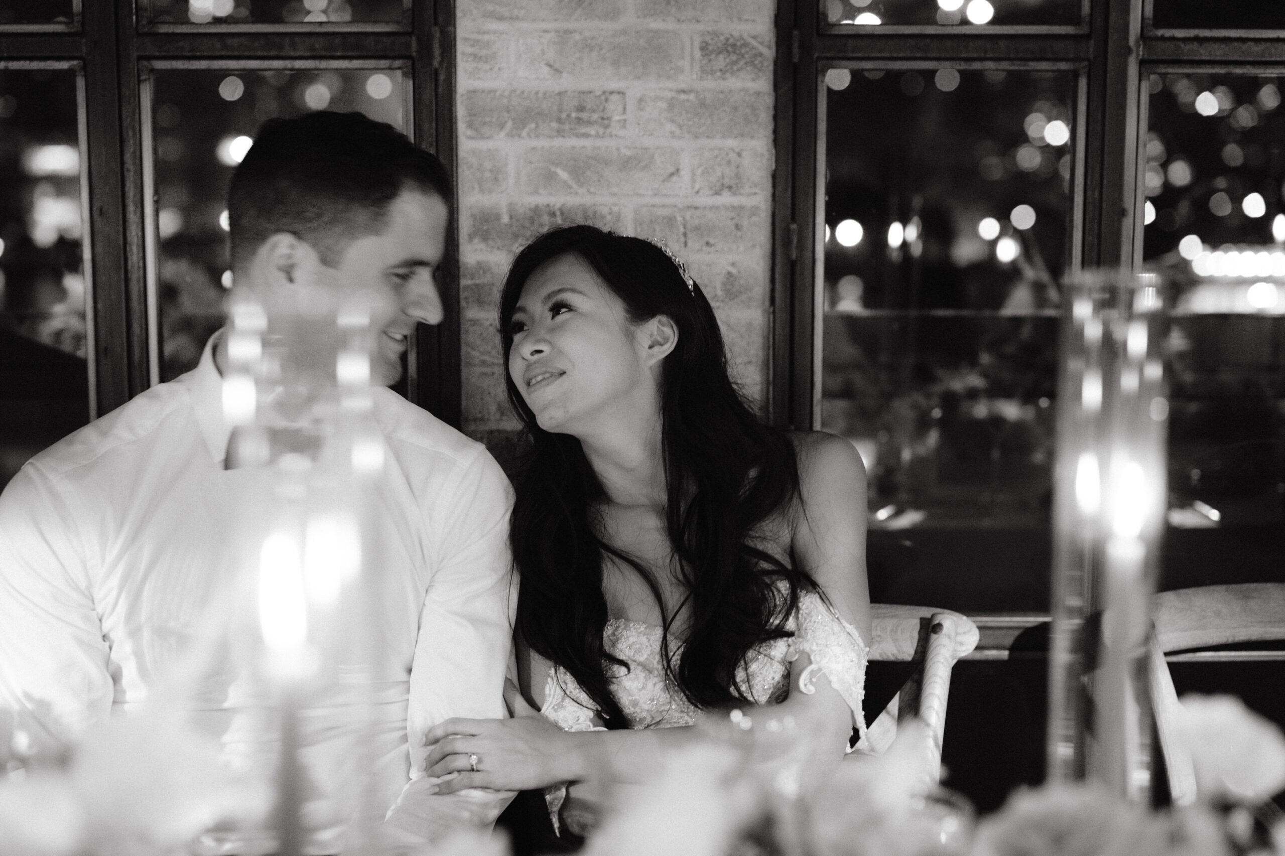 Black and white image of the bride and groom in the wedding reception. Honeymoon destination image by Jenny Fu Studio