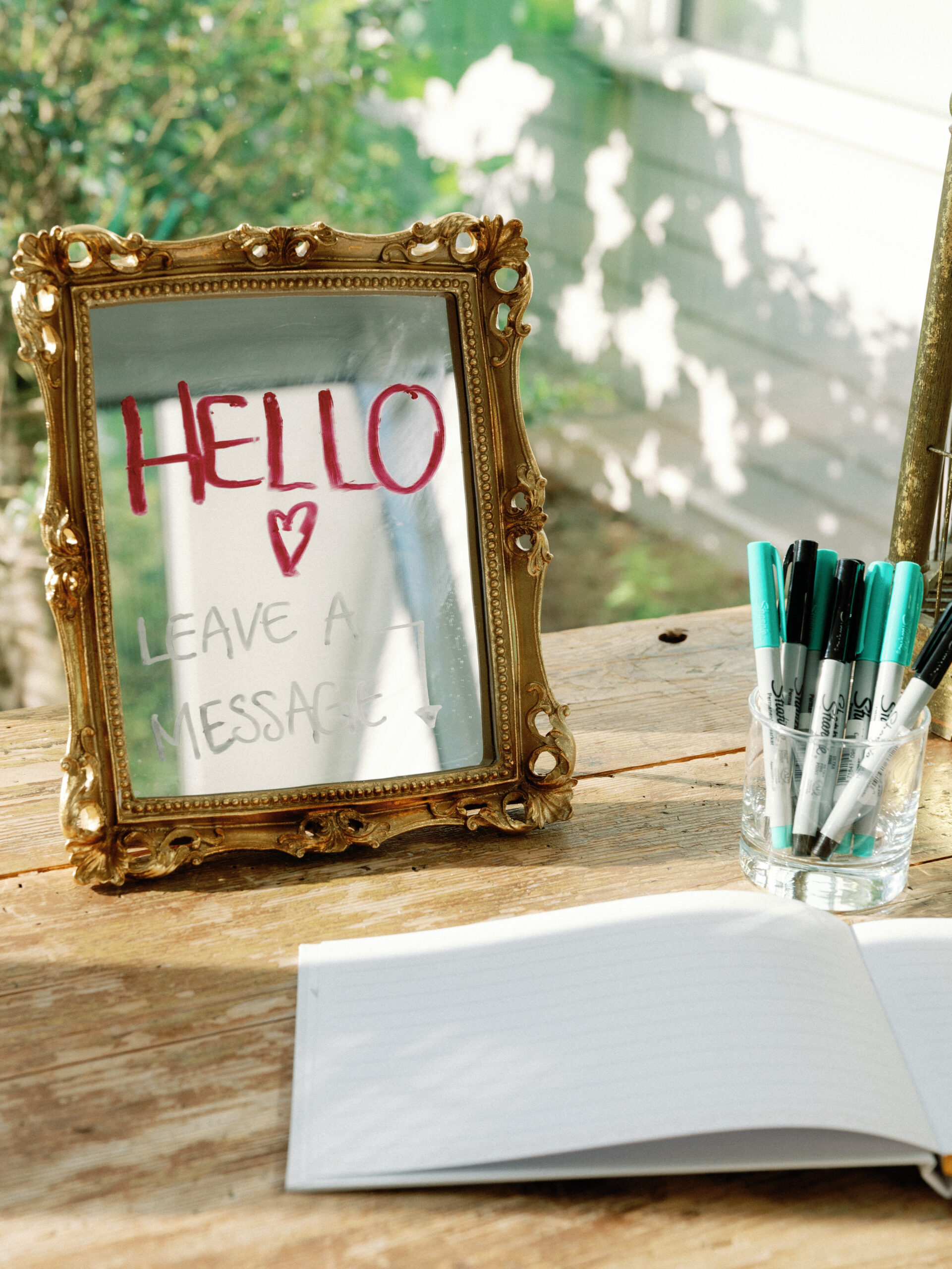 Wedding book and a jar of pens placed on a wooden table. Fine art wedding photography image by Jenny Fu Studio