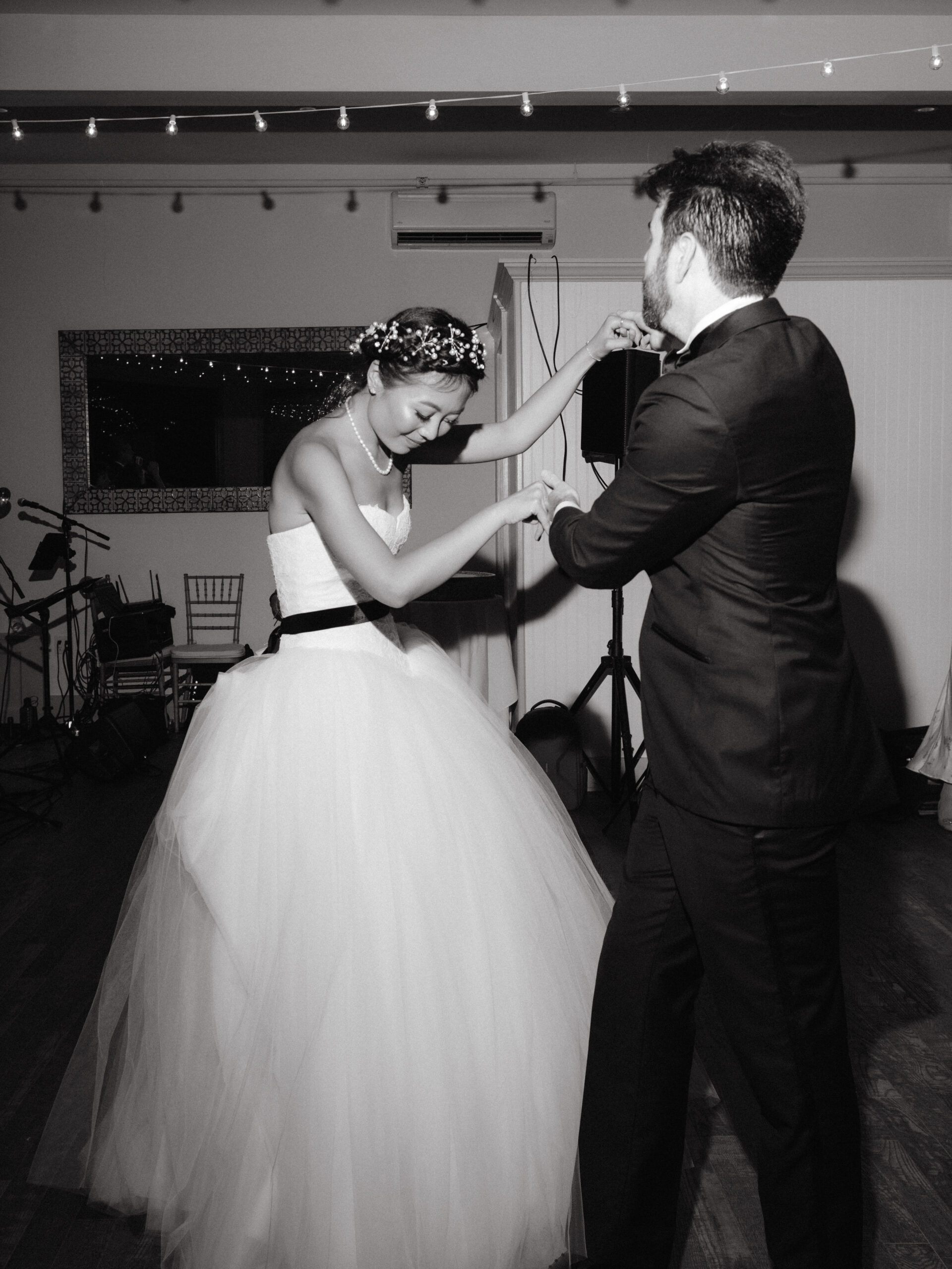 Editorial photo of the bride and groom while dancing. Image by Jenny Fu Studio