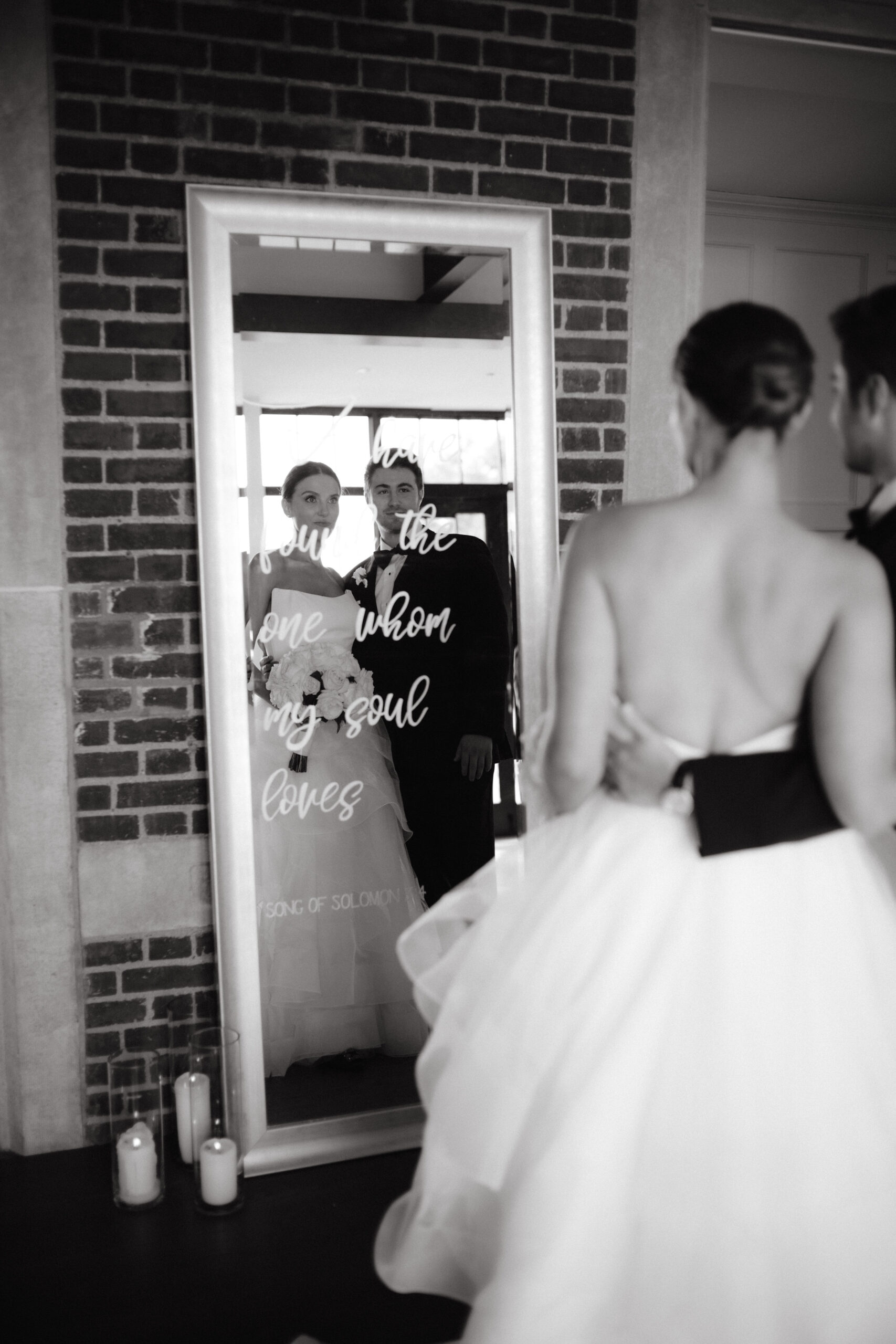 Editorial image of the bride and groom looking at a mirror. Timeless wedding photography Image by Jenny Fu Studio