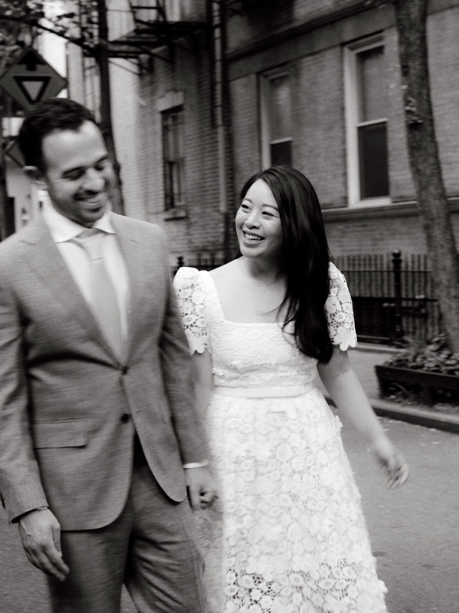 Editorial photo of the engaged couple happily walking in the streets of New York. Image by Jenny Fu Studio
