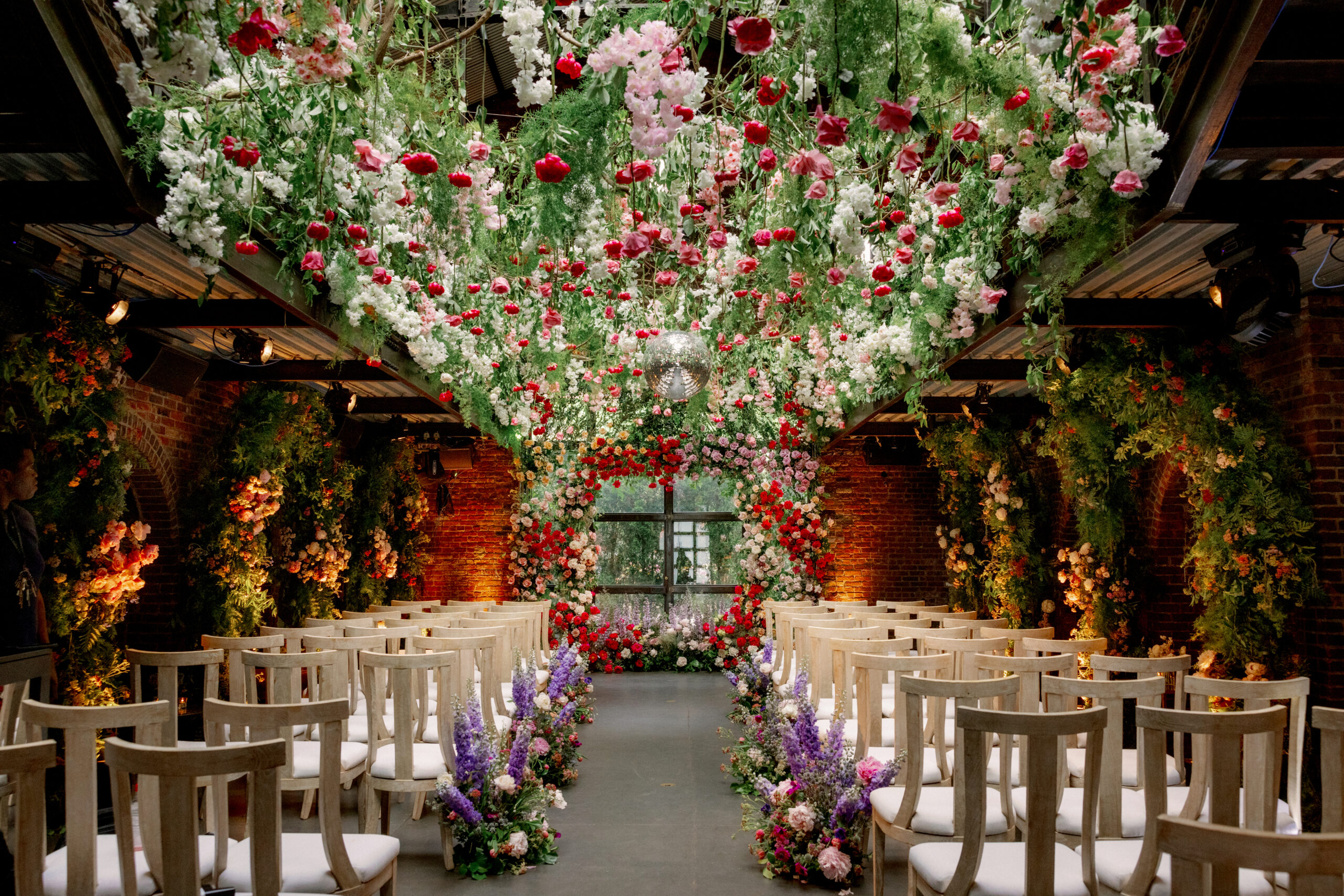 Beautiful ceremony backdrop filled with flowers. Wedding details image by Jenny Fu Studio