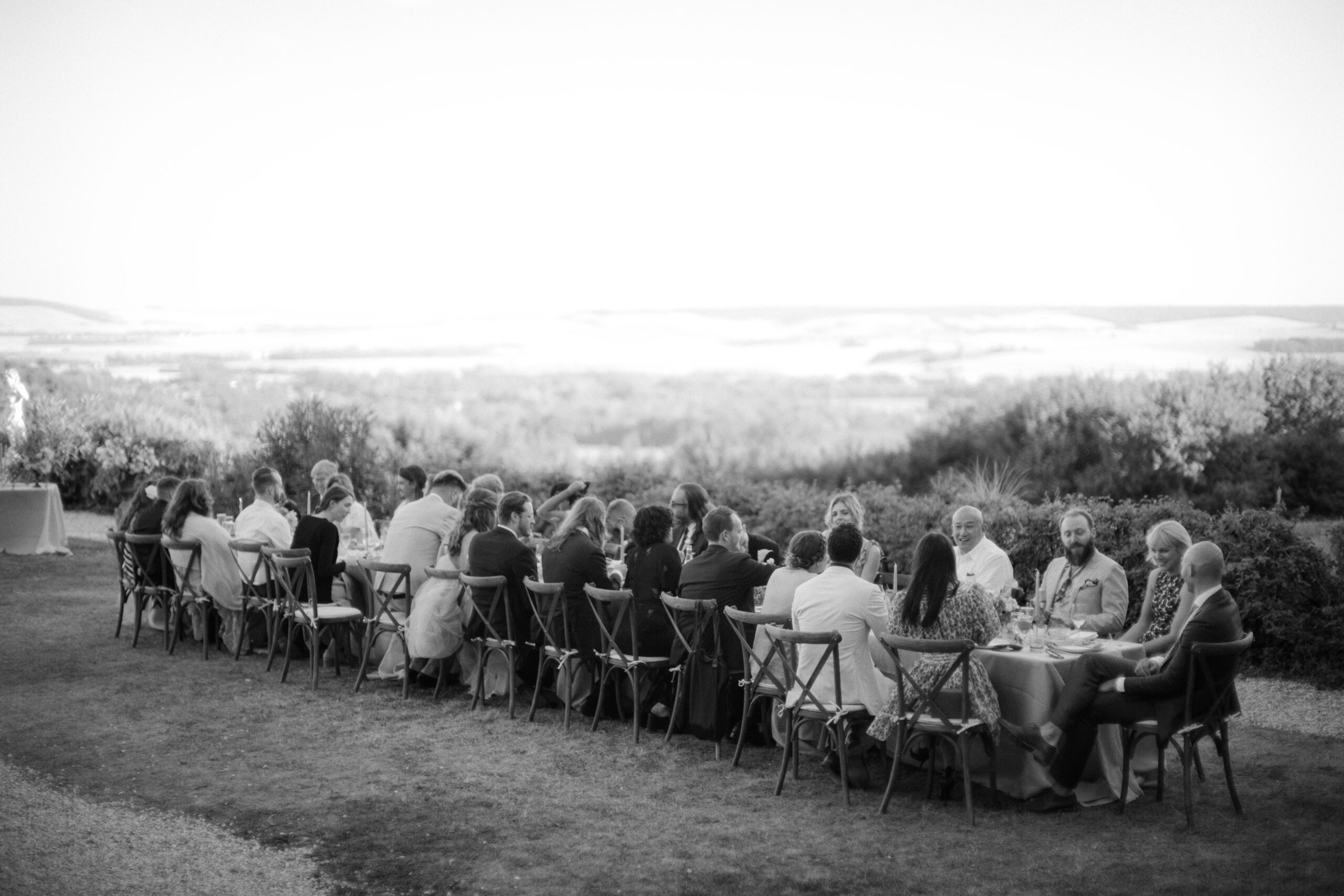 Black and white image of a wedding reception outdoors at Chateau Du Fey. Wedding in  France photo by Jenny Fu Studio