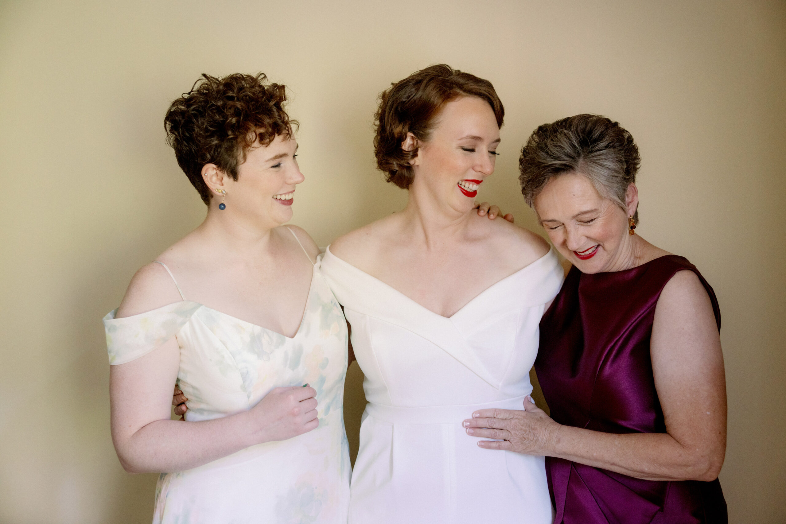 The bride, her sister and mother are smiling lovingly together. Wedding poses image by Jenny Fu Studio