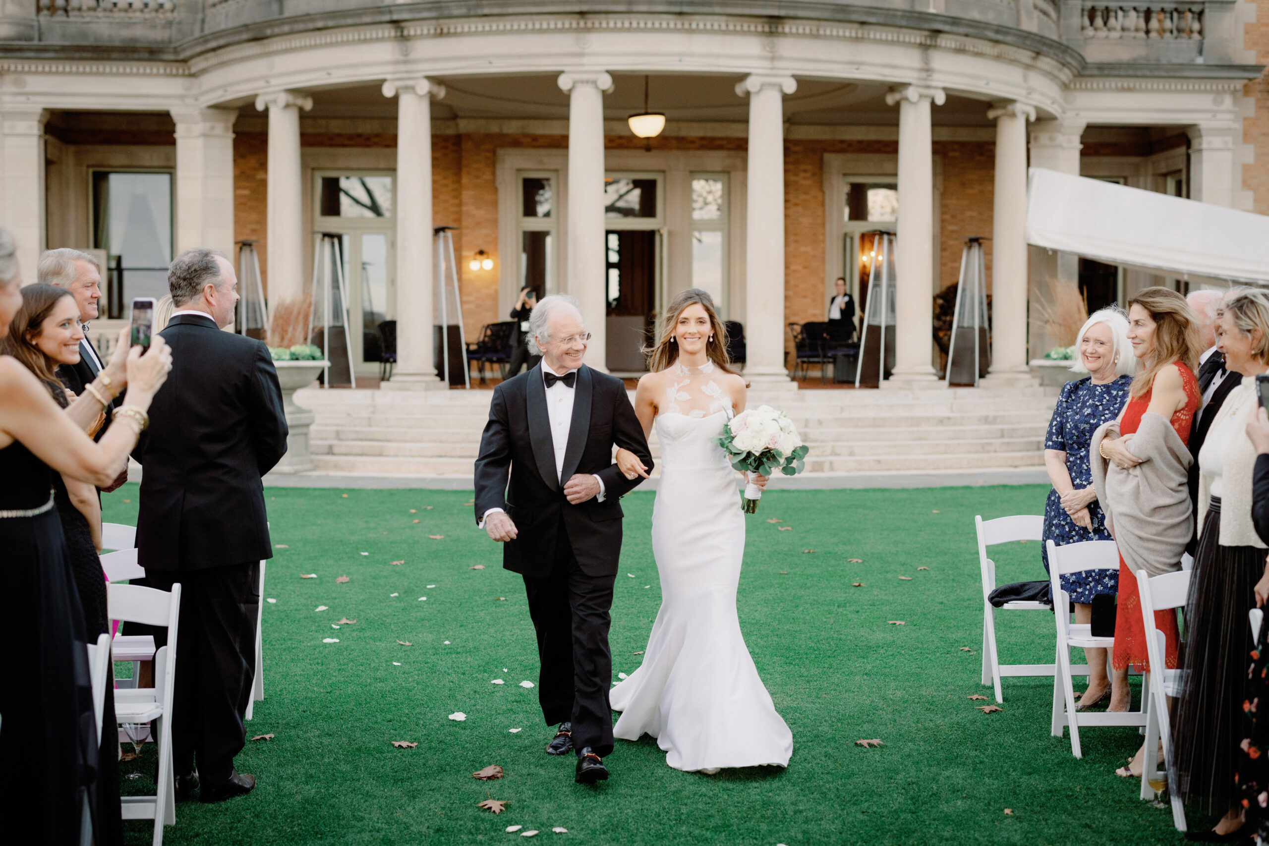 Editorial image of the bride walking down the aisle with her father at Sleepy Hollow Country Club, NY. Image by Jenny Fu Studio