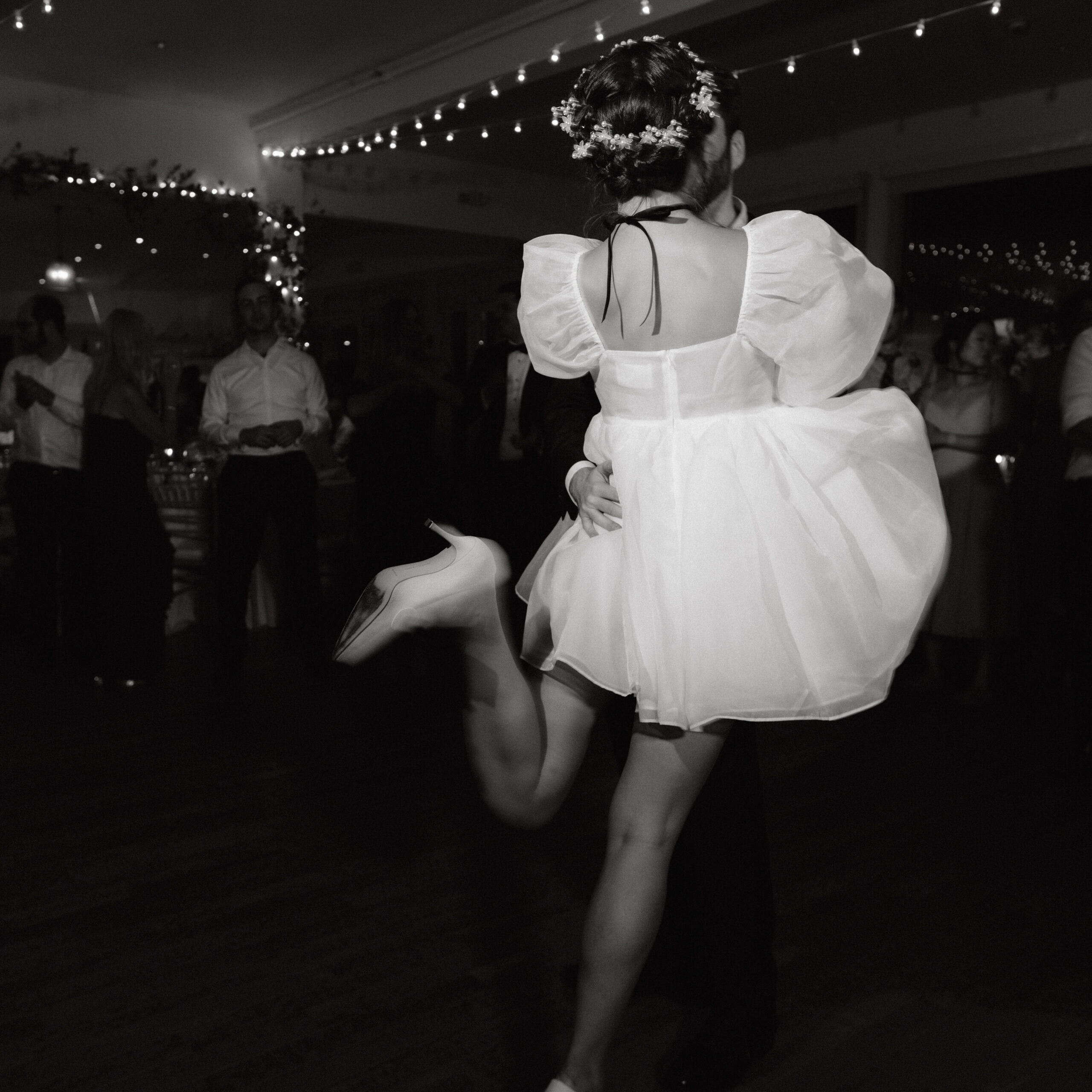 Black and white image of the bride and groom dancing. Image by Jenny Fu Studio