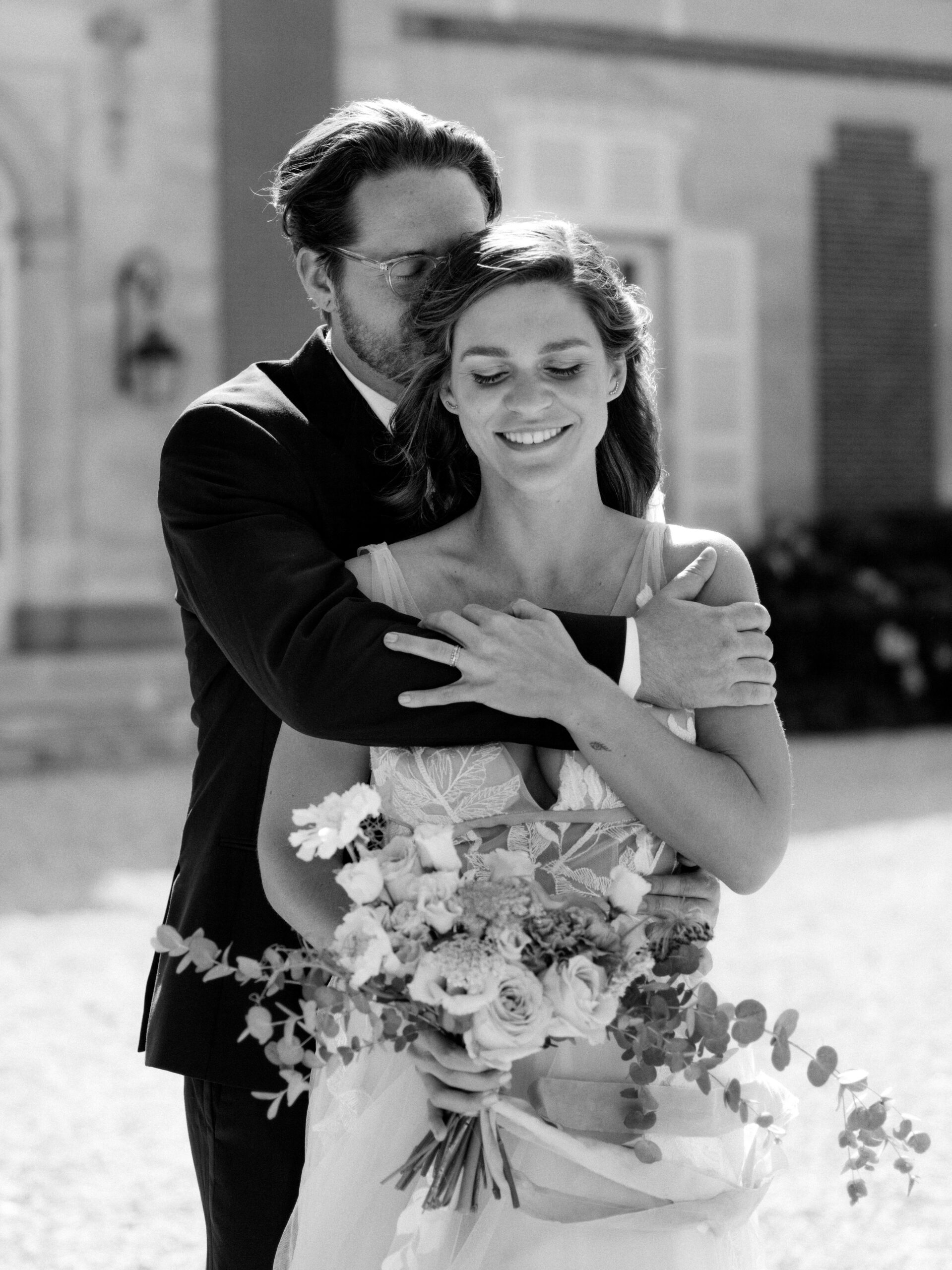 Black and white image of the bride and groom hugging each other at Chateau Du Fey. Wedding in  France photo by Jenny Fu Studio