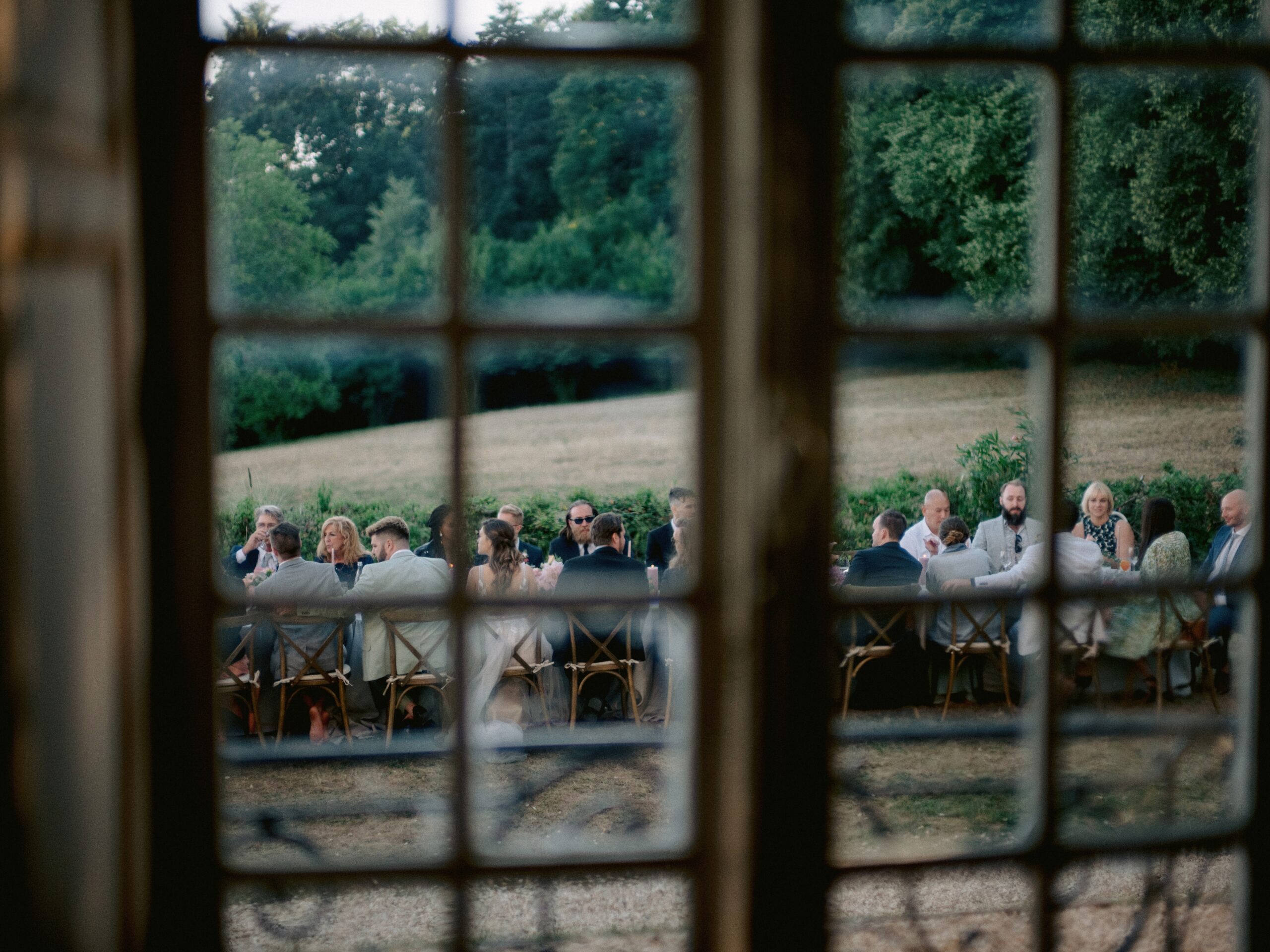 A view of a wedding reception from inside the window. Photo by Jenny Fu Studio