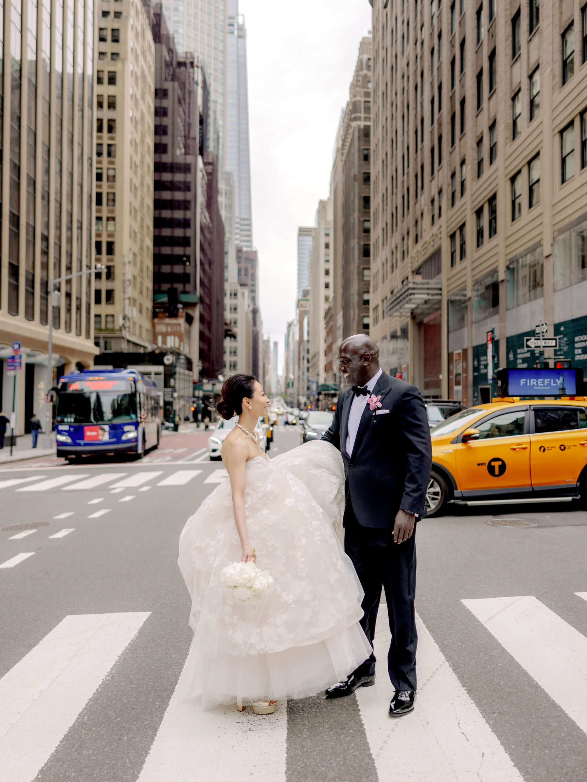 Editorial image of the bride and groom crossing the streets of NYC. Photojournalistic image by Jenny Fu Studio