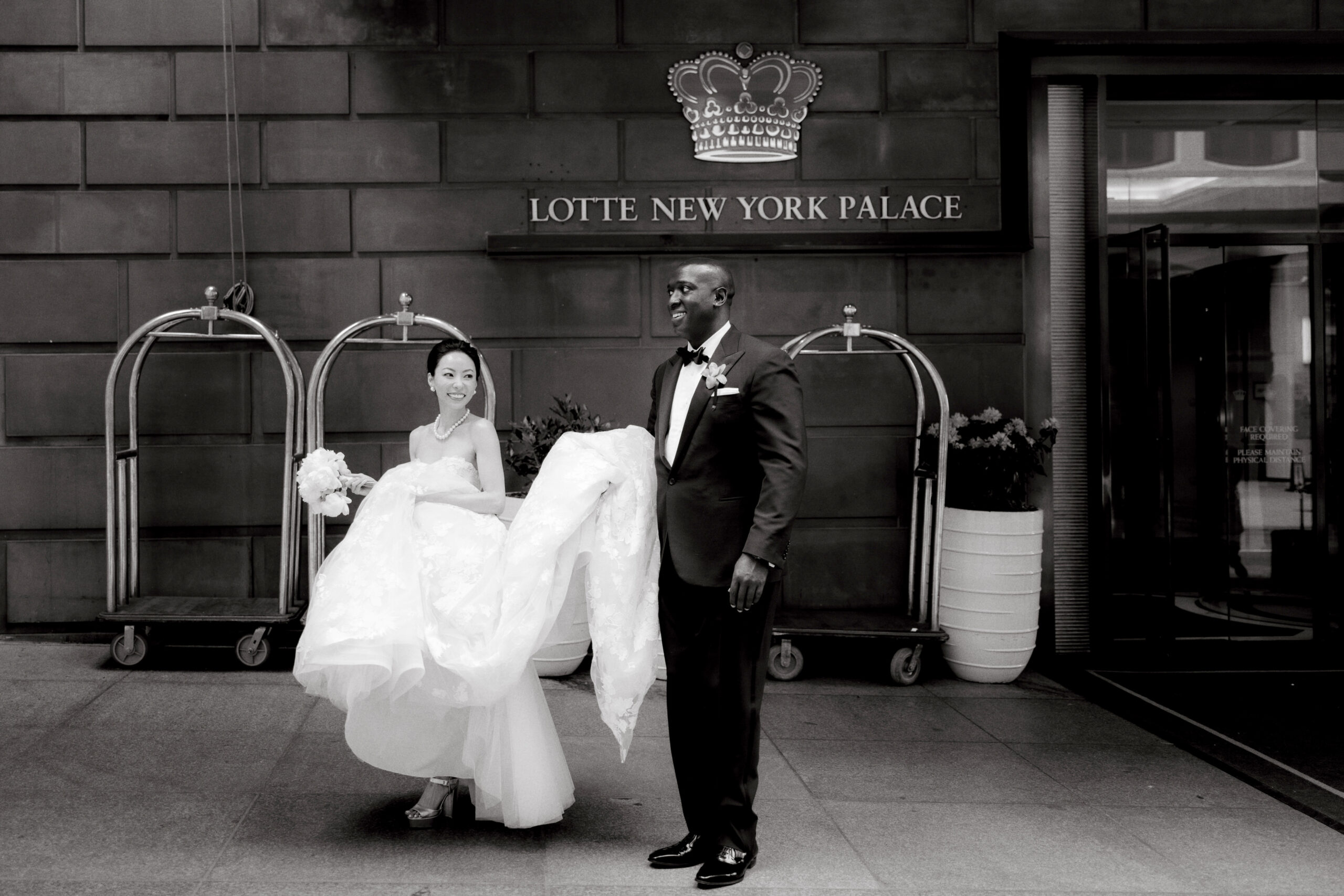 Black and white photo of the bride and groom at Lotte New York Palace. Wedding photography styles image by Jenny Fu Studio
