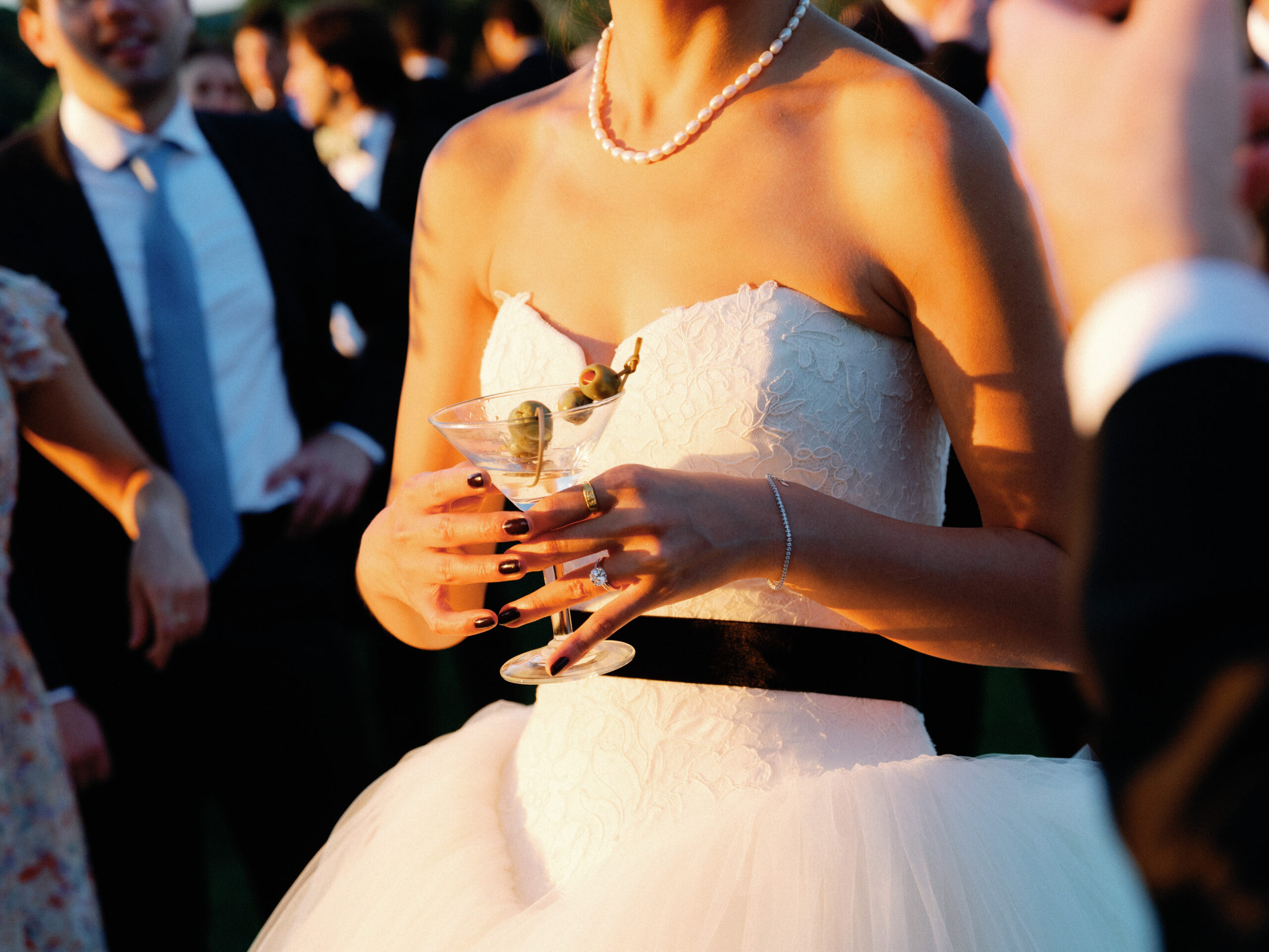 Half-body, close up shot of the bride holding a glass of champagne. Image by Jenny Fu Studio