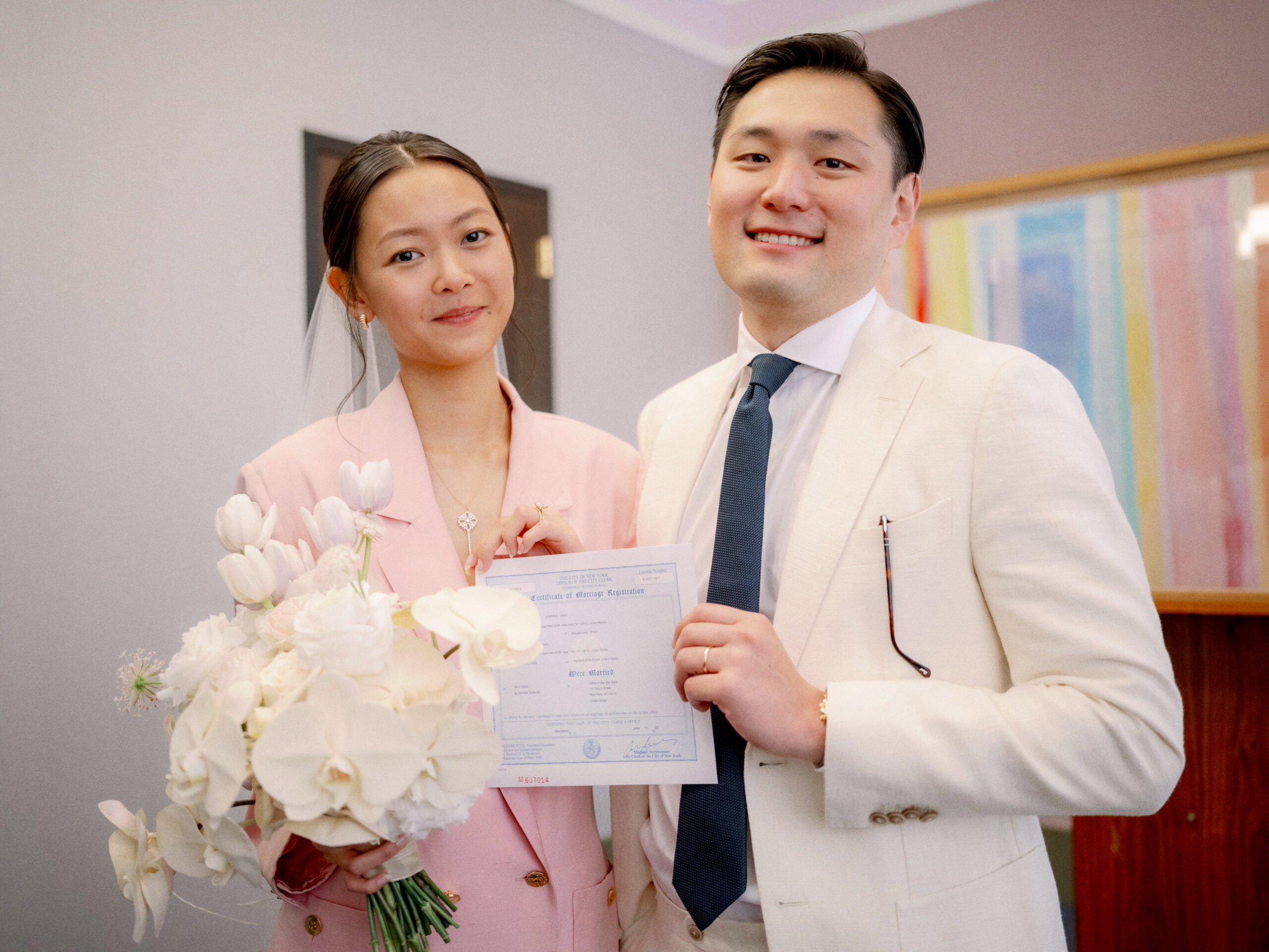 The newlyweds are holding their marriage certificate. Documentary Wedding Photography Image by Jenny Fu Studio