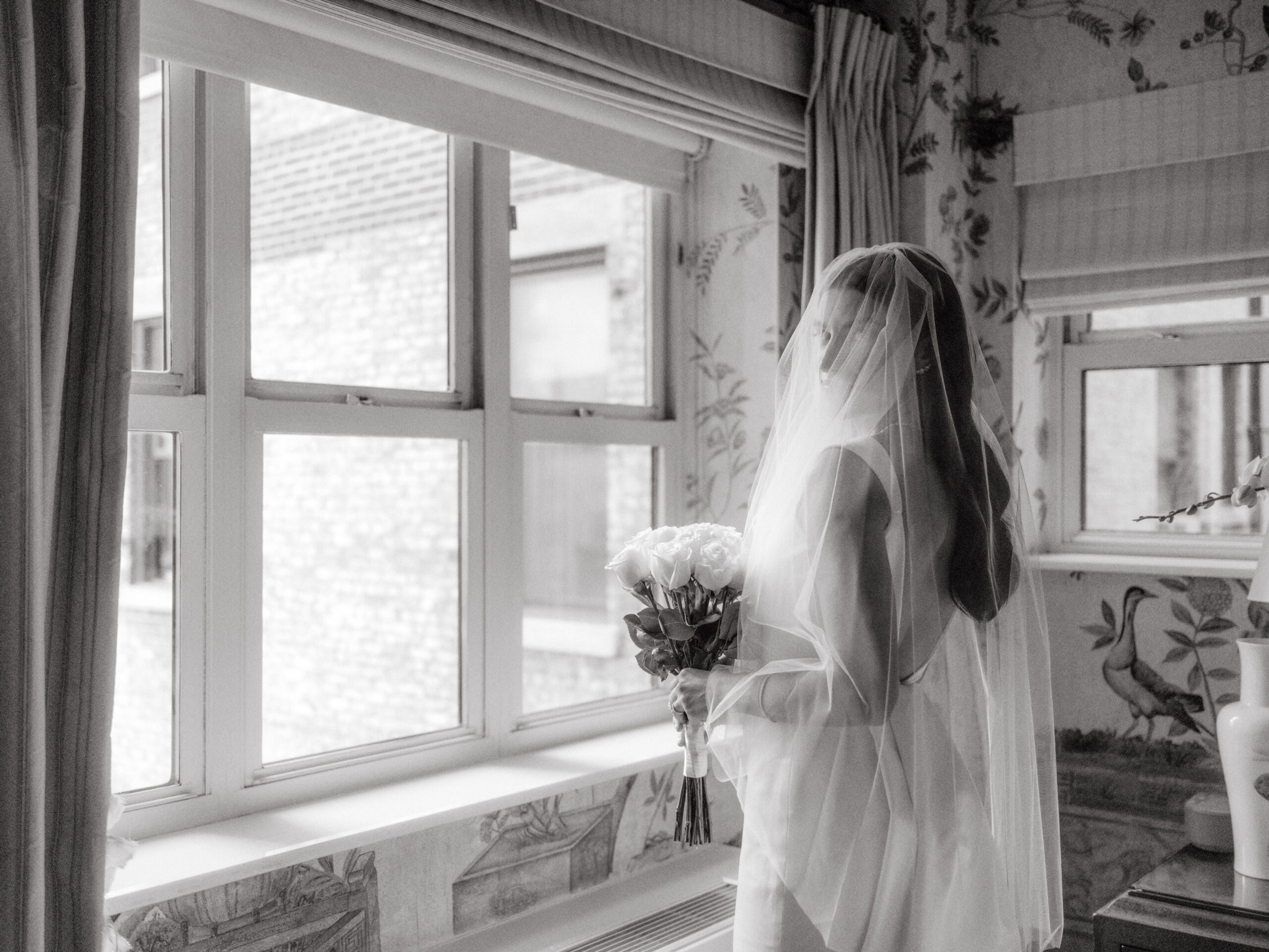 Editorial black and white image of the bride before the ceremony. Timeless Wedding Photography by Jenny Fu Studio.