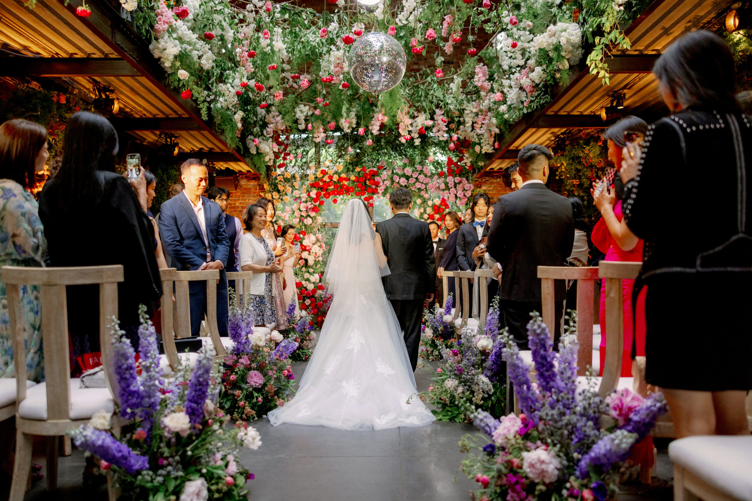 Beautiful wedding ceremony with lots of flowers at The Foundry. High-quality wedding photography image by Jenny Fu Studio